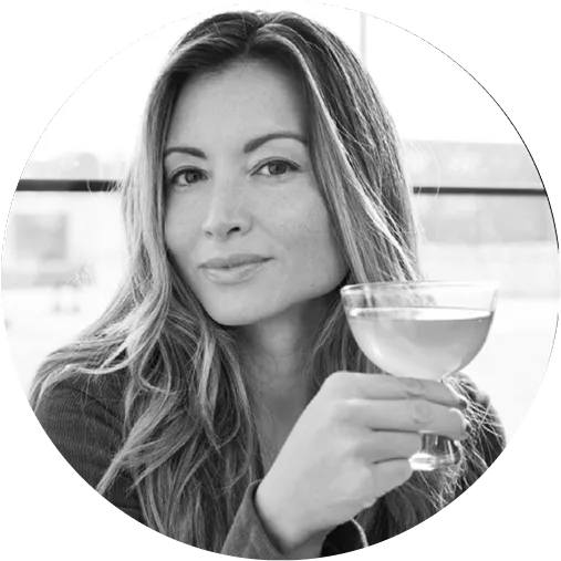 A woman holding a glass of wine.