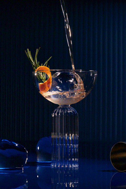 A glass of water with a slice of orange in it.