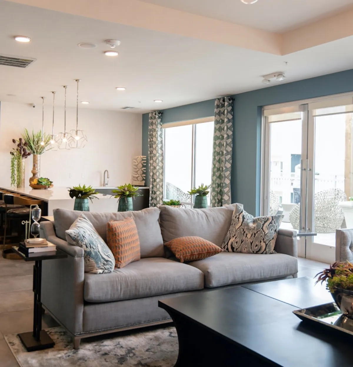A living room filled with furniture and lots of windows.