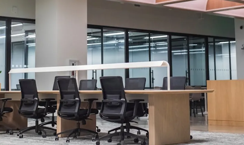 A conference room with a long table and chairs.