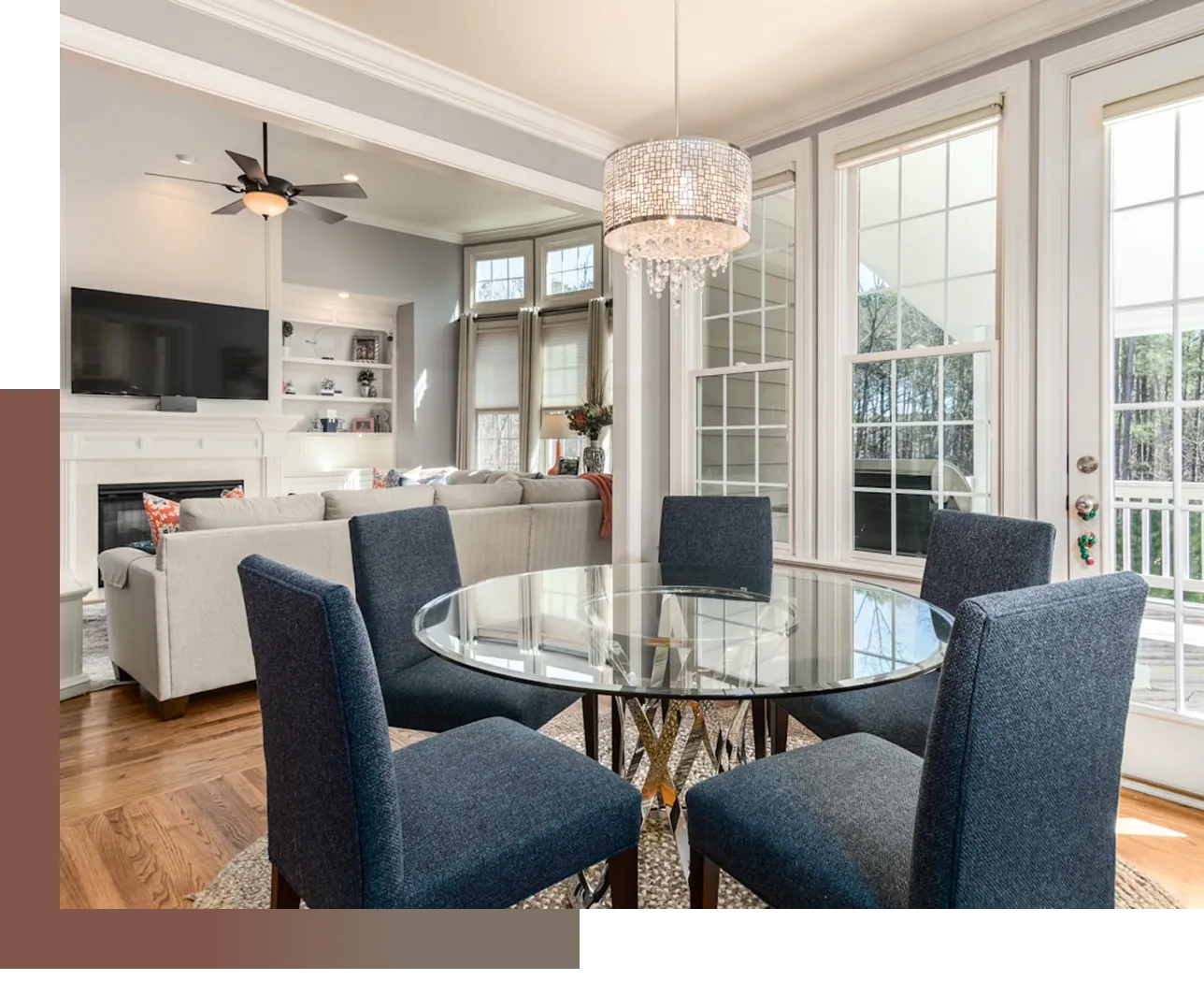 A dining room with a glass table and blue chairs.