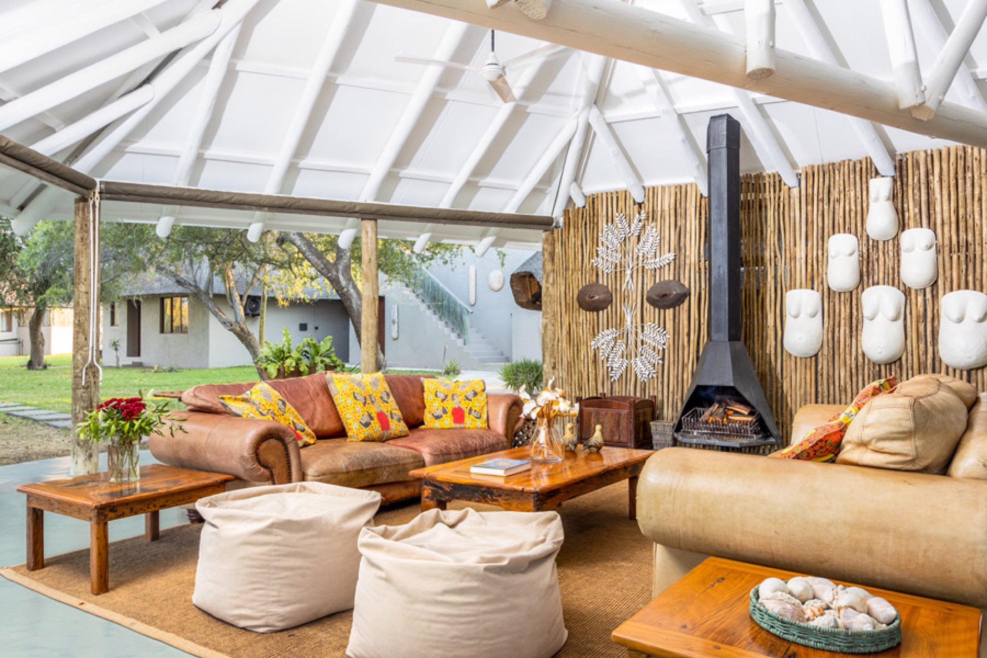 An open lounge with cushions and a fireplace