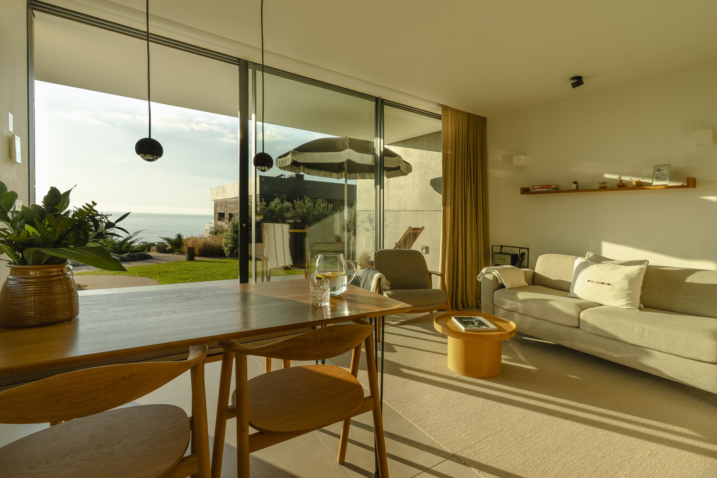 Open-plan living and dining space looking out to the sea