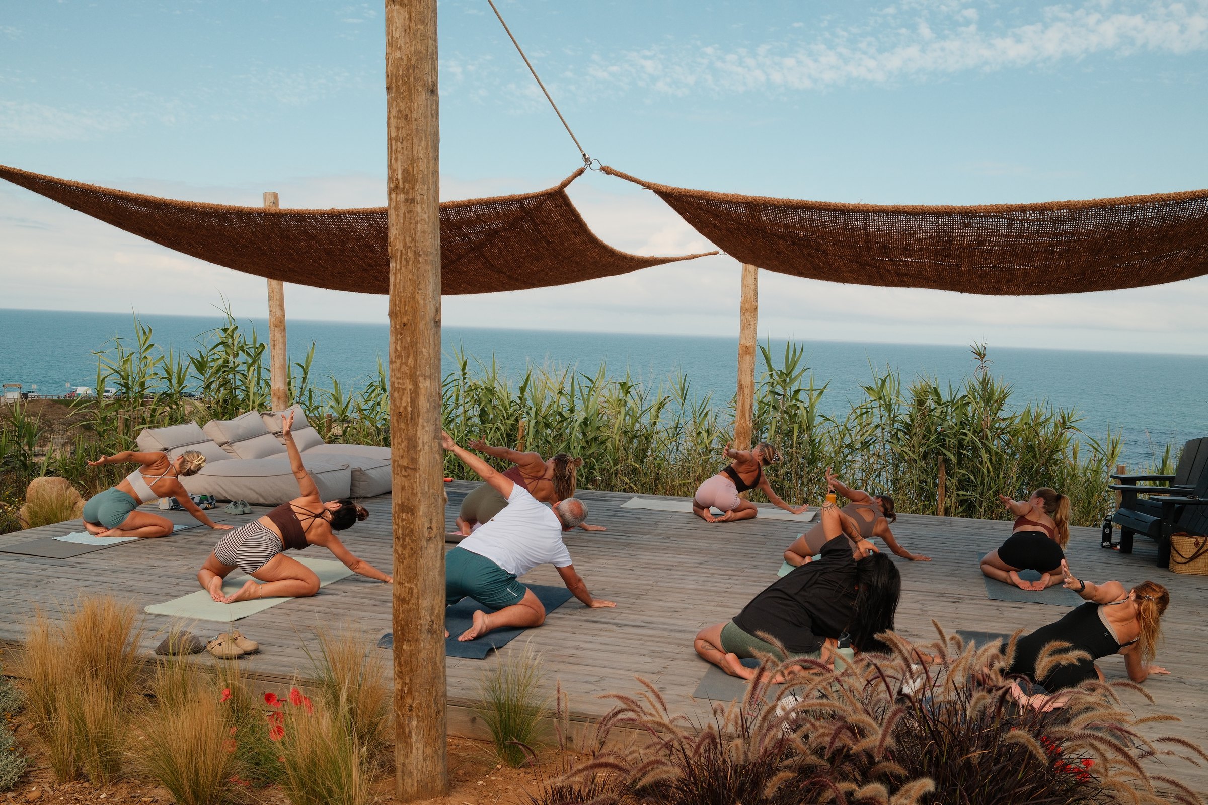 Morning practice on mats on the ocean-facing deck