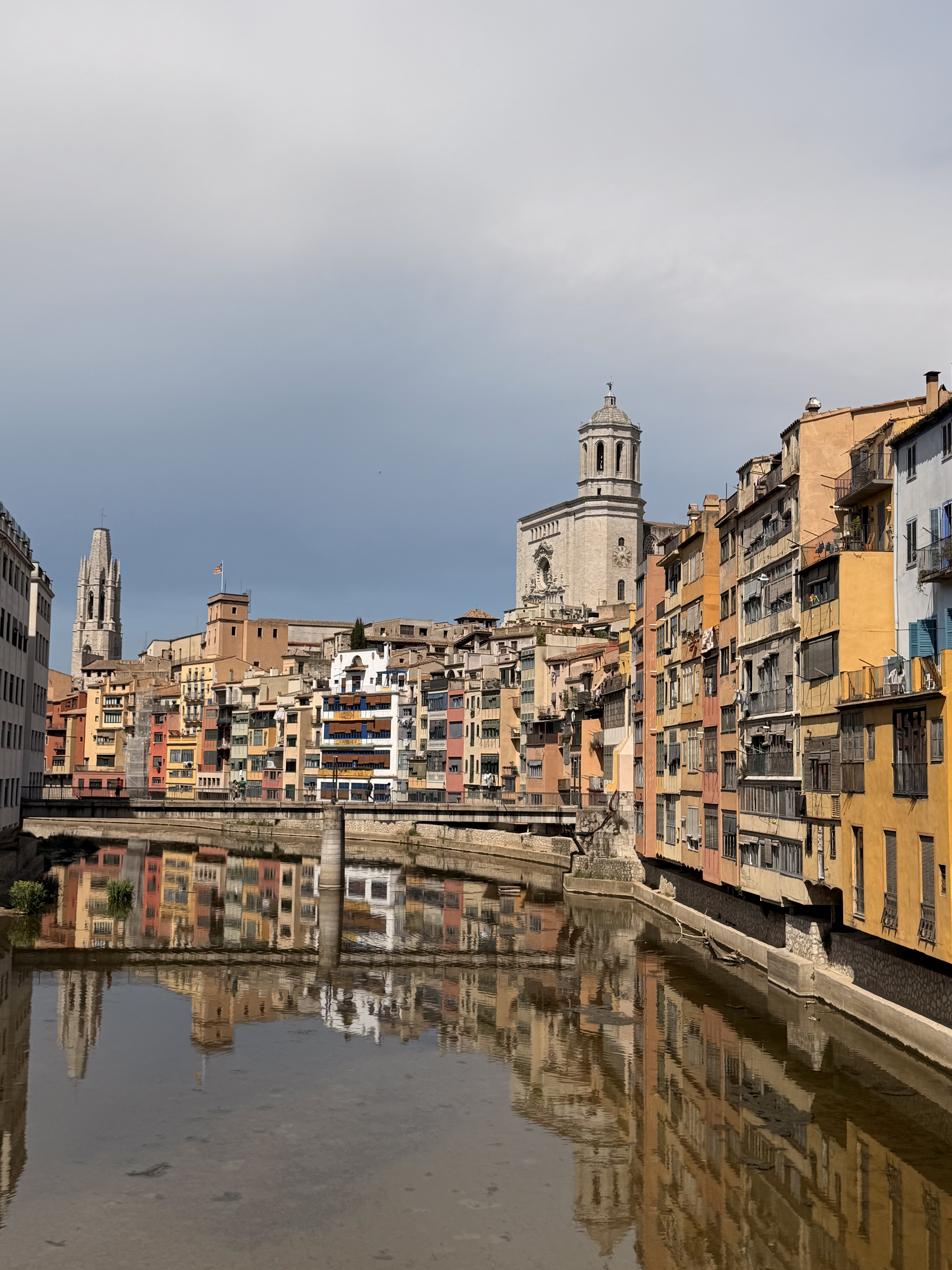 The coloured riverfront houses of Girona reflected in the Onyar
