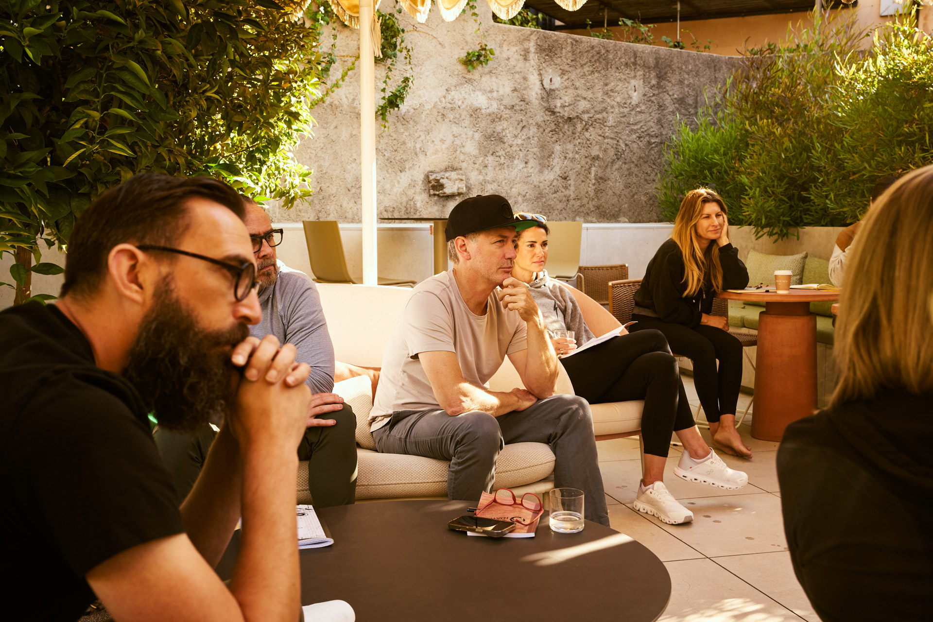 Workshop session with participants seated on low couches in discussion