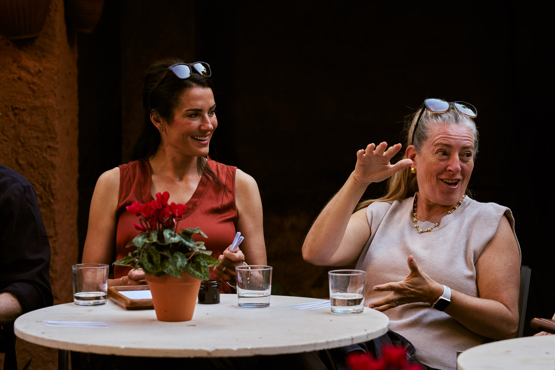 Two participants in conversation at a small table