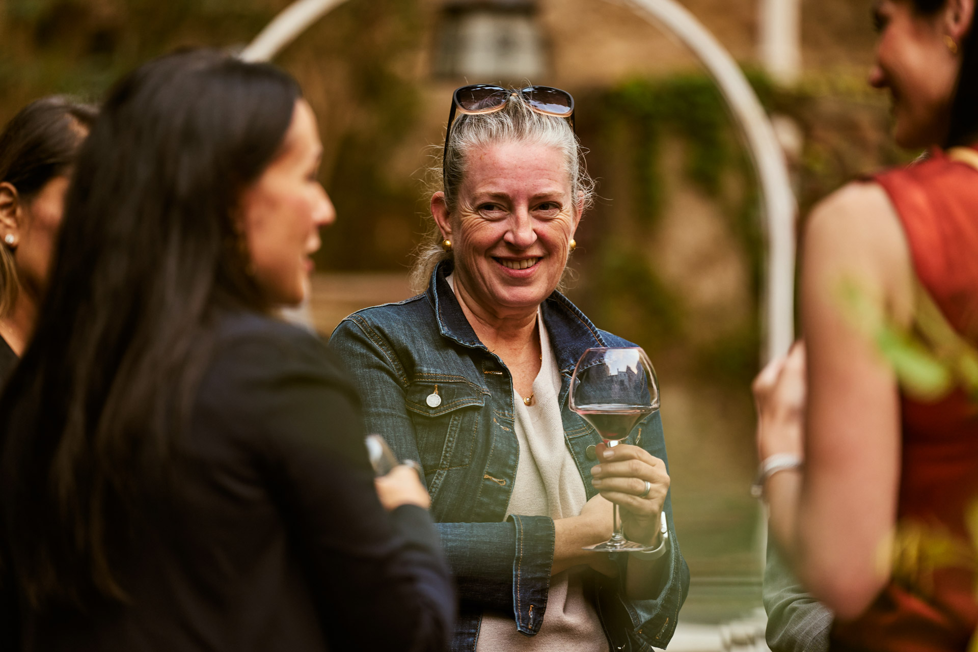 Guests talking and laughing with wine in the garden