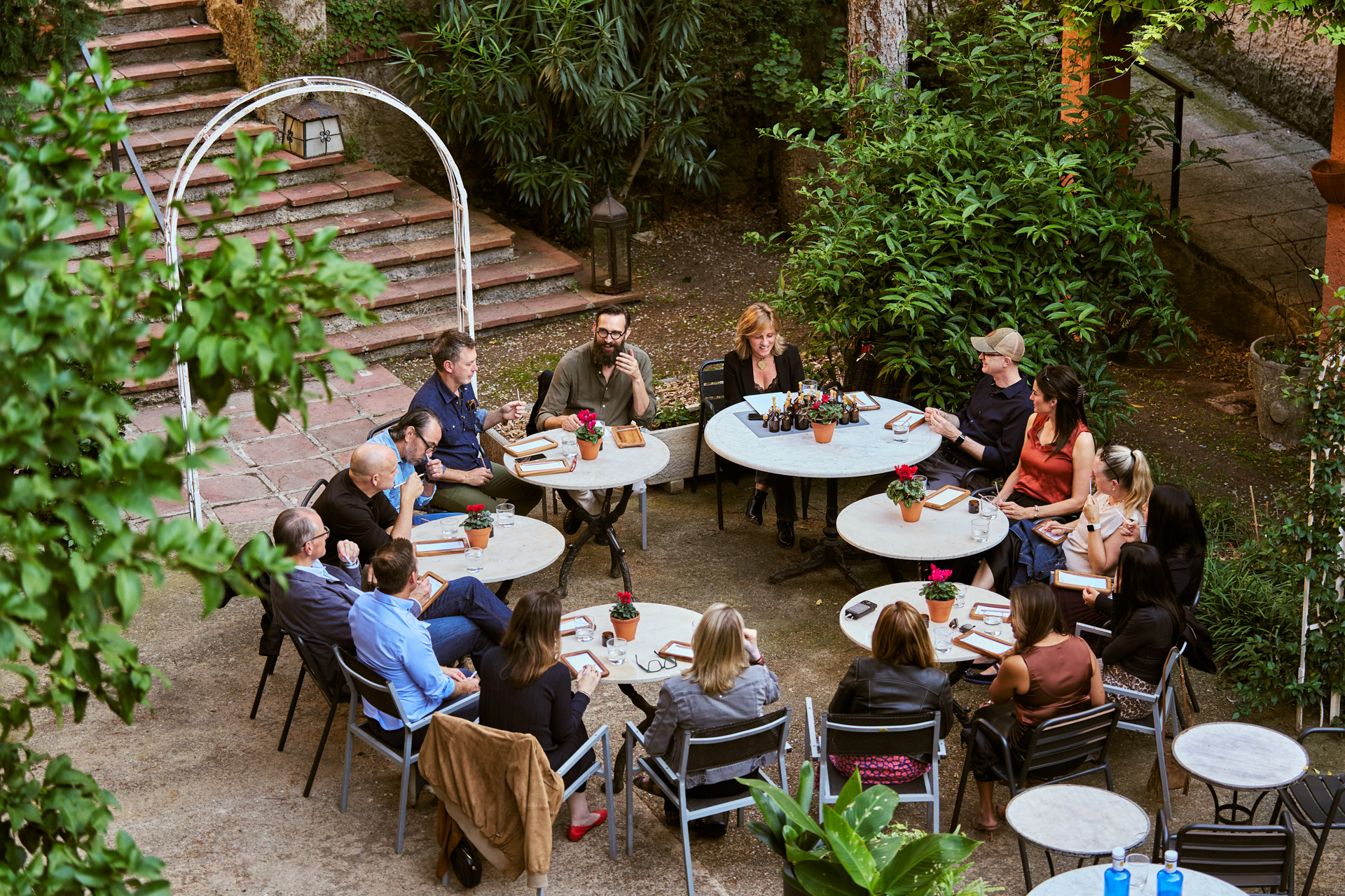 Overhead view of the group at cafe tables in a garden courtyard