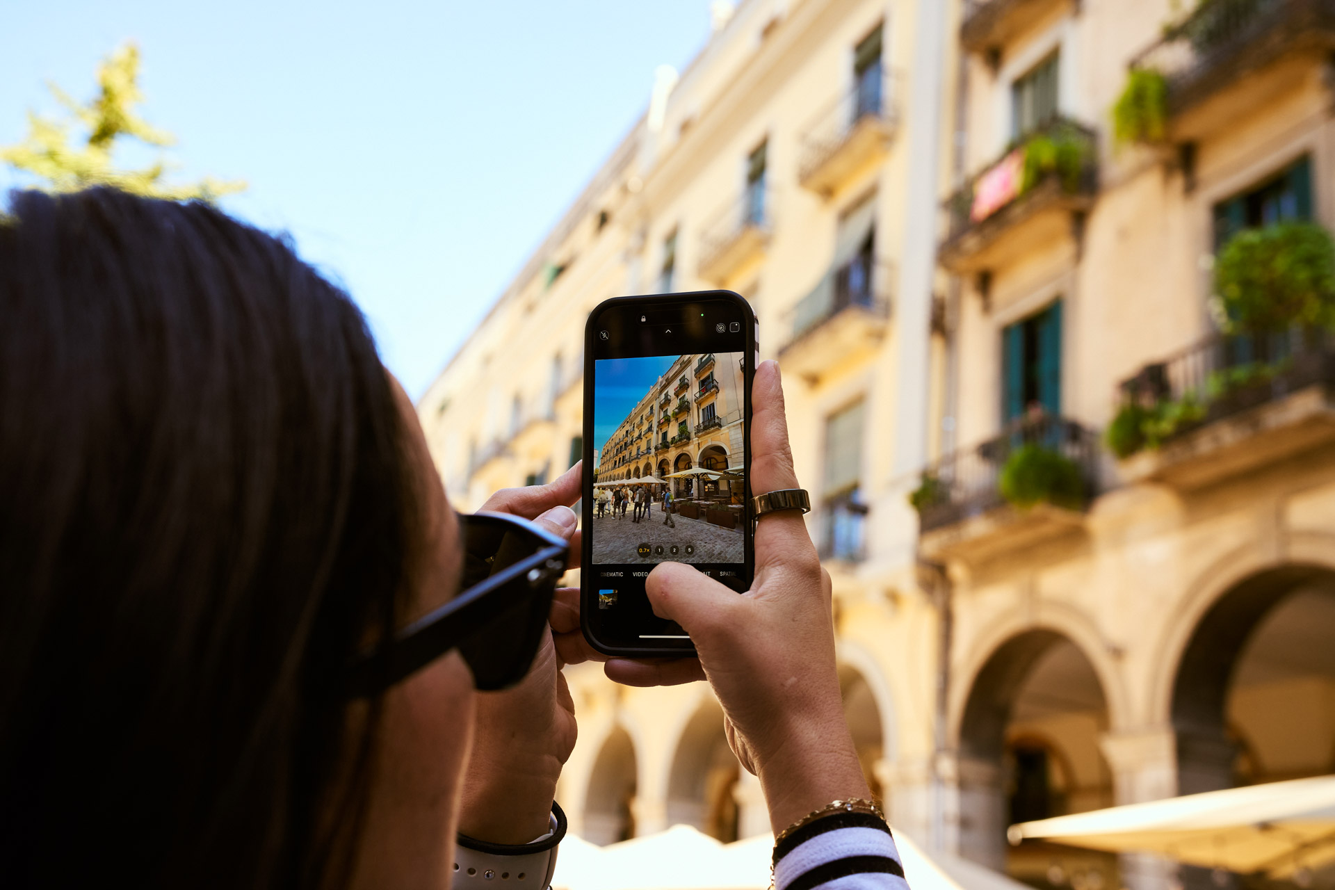 Photographing the arcaded old-town buildings on a phone