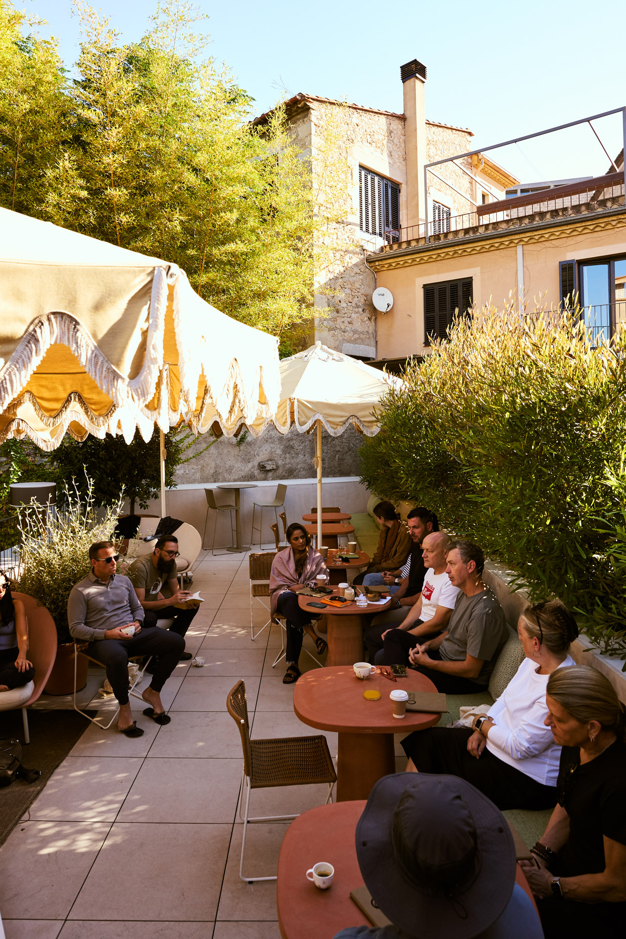 Cafe terrace under umbrellas in a shaded square