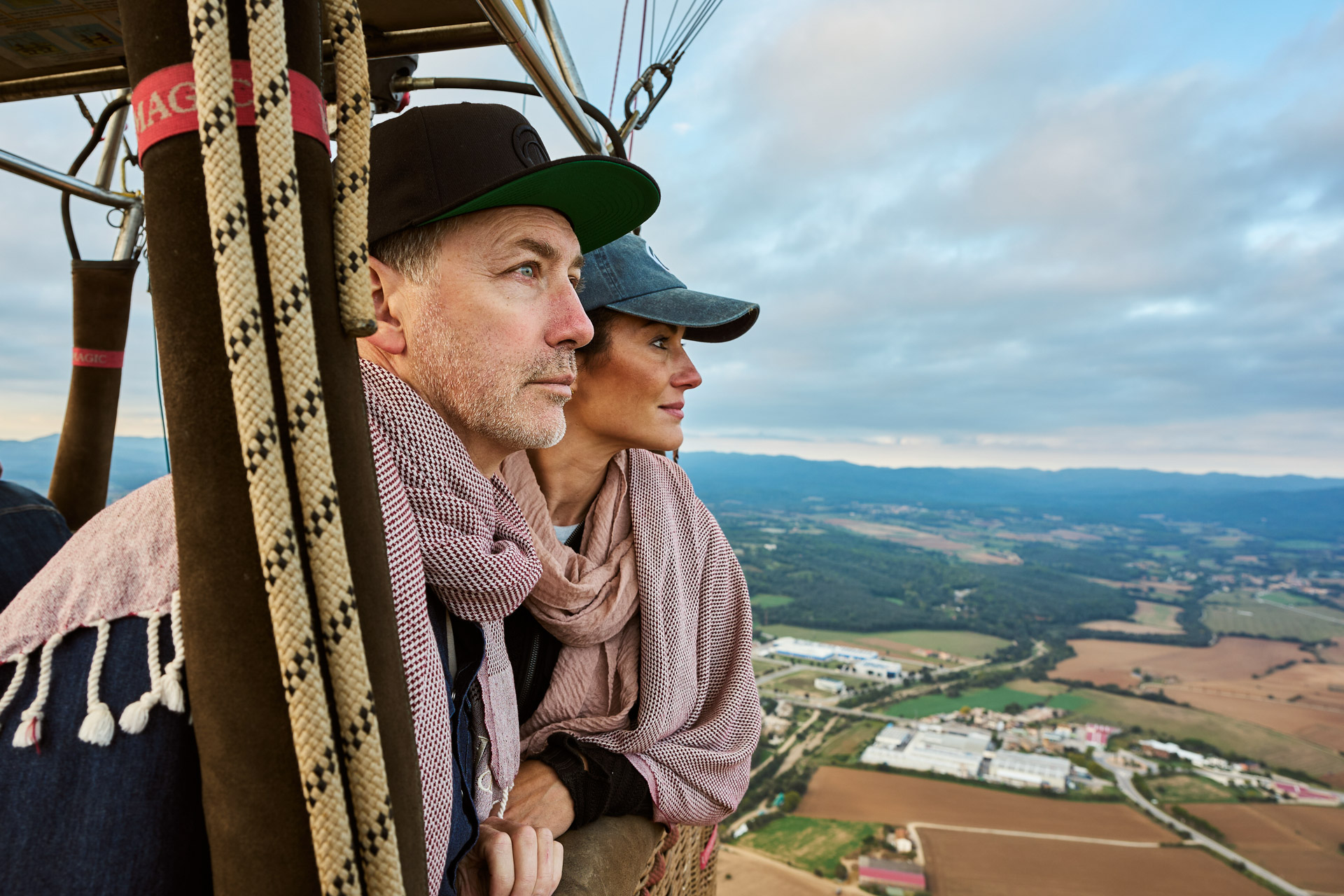 Two participants in the balloon basket looking out over the fields