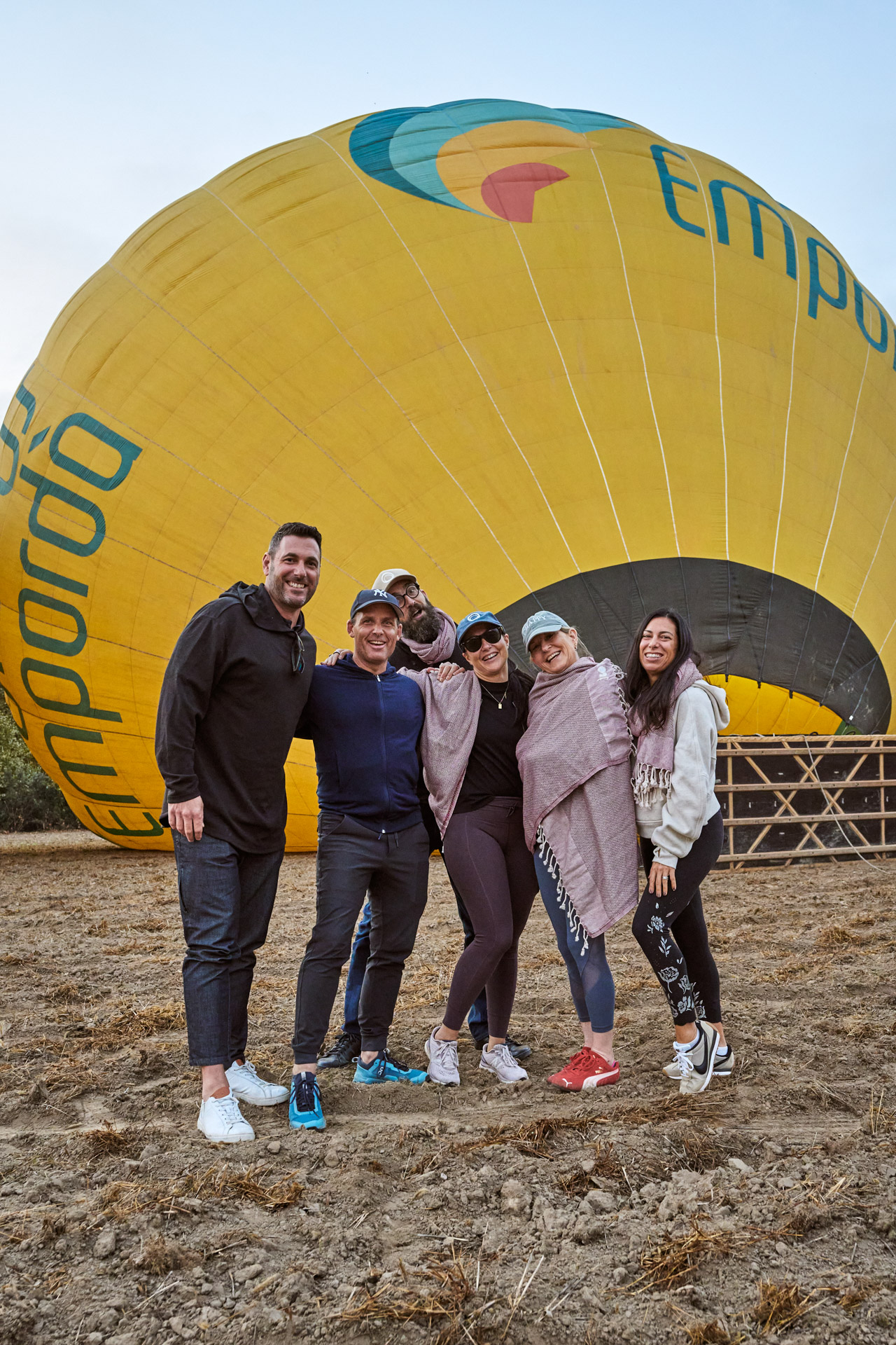 Participants posing in front of an inflated hot-air balloon