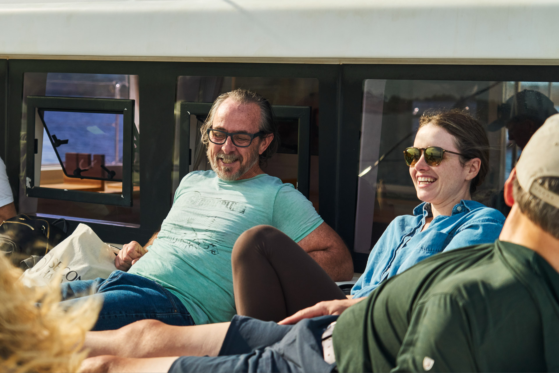Two participants relaxing in the catamaran's saloon