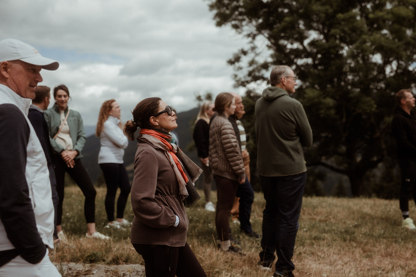 Participants talking together in a hillside meadow