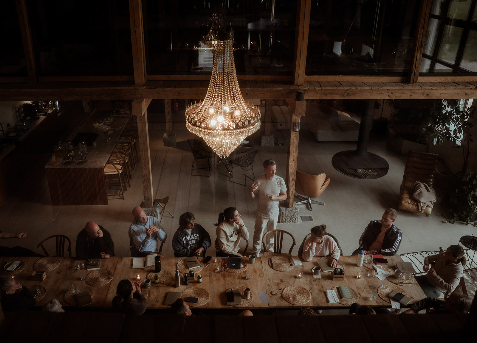 Evening workshop beneath a chandelier in the converted barn