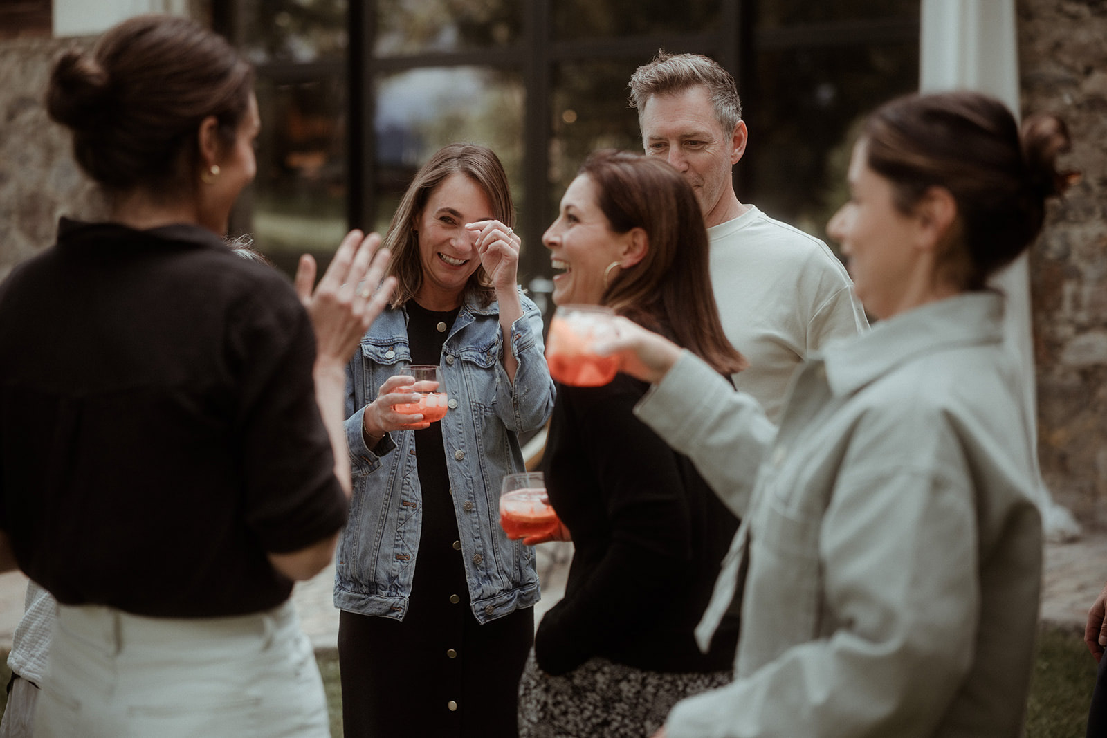 Guests toasting with spritzes before dinner