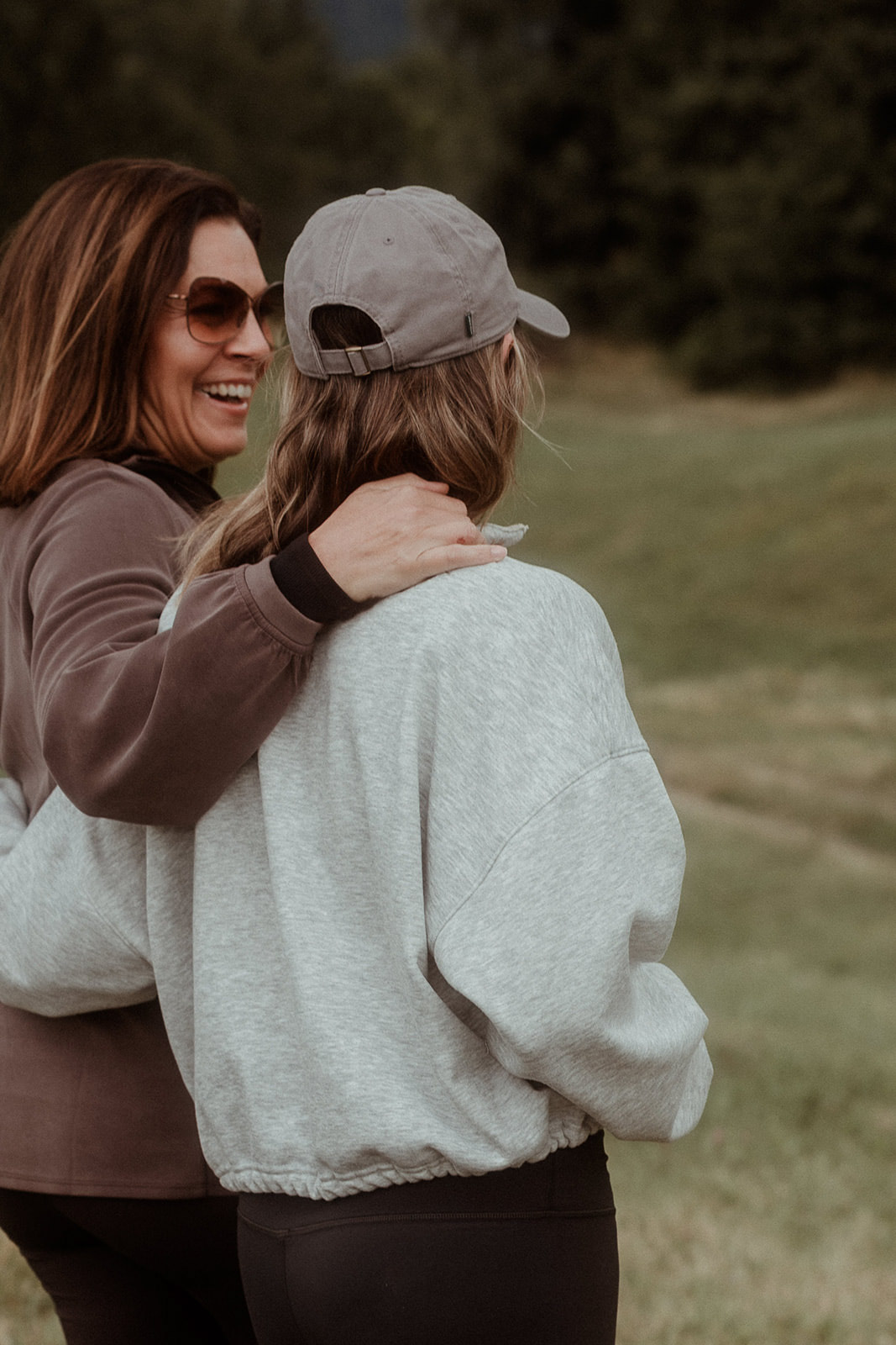 Two participants embracing in the meadow