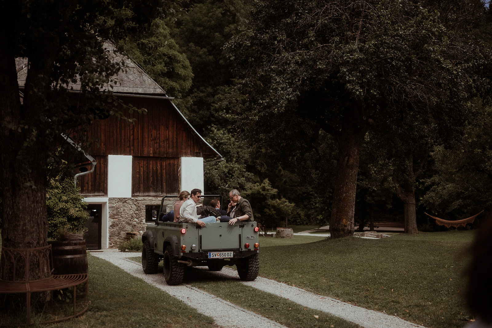An open-top vehicle parked by the barn in the grounds