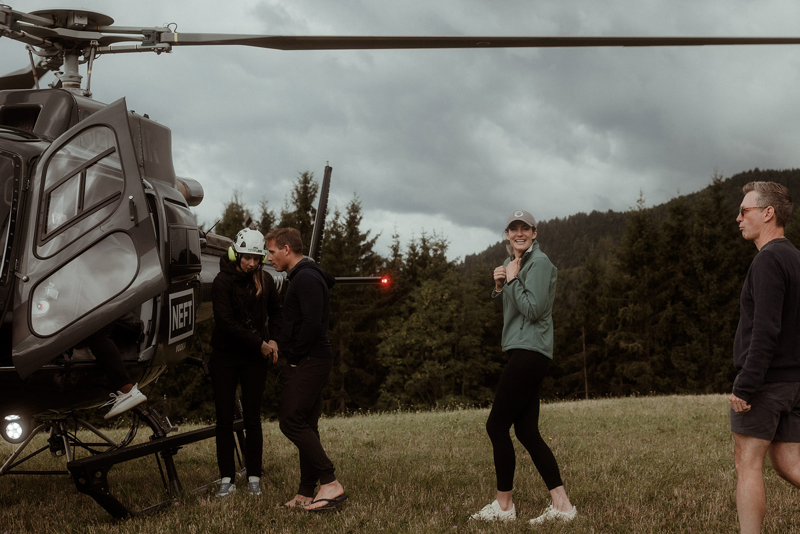 The group boarding a helicopter in the field