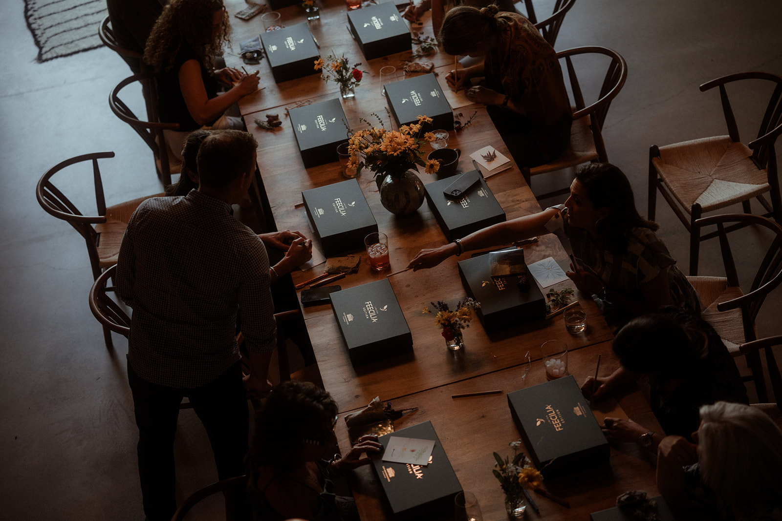 Overhead view of the dinner table set with a gift at each place
