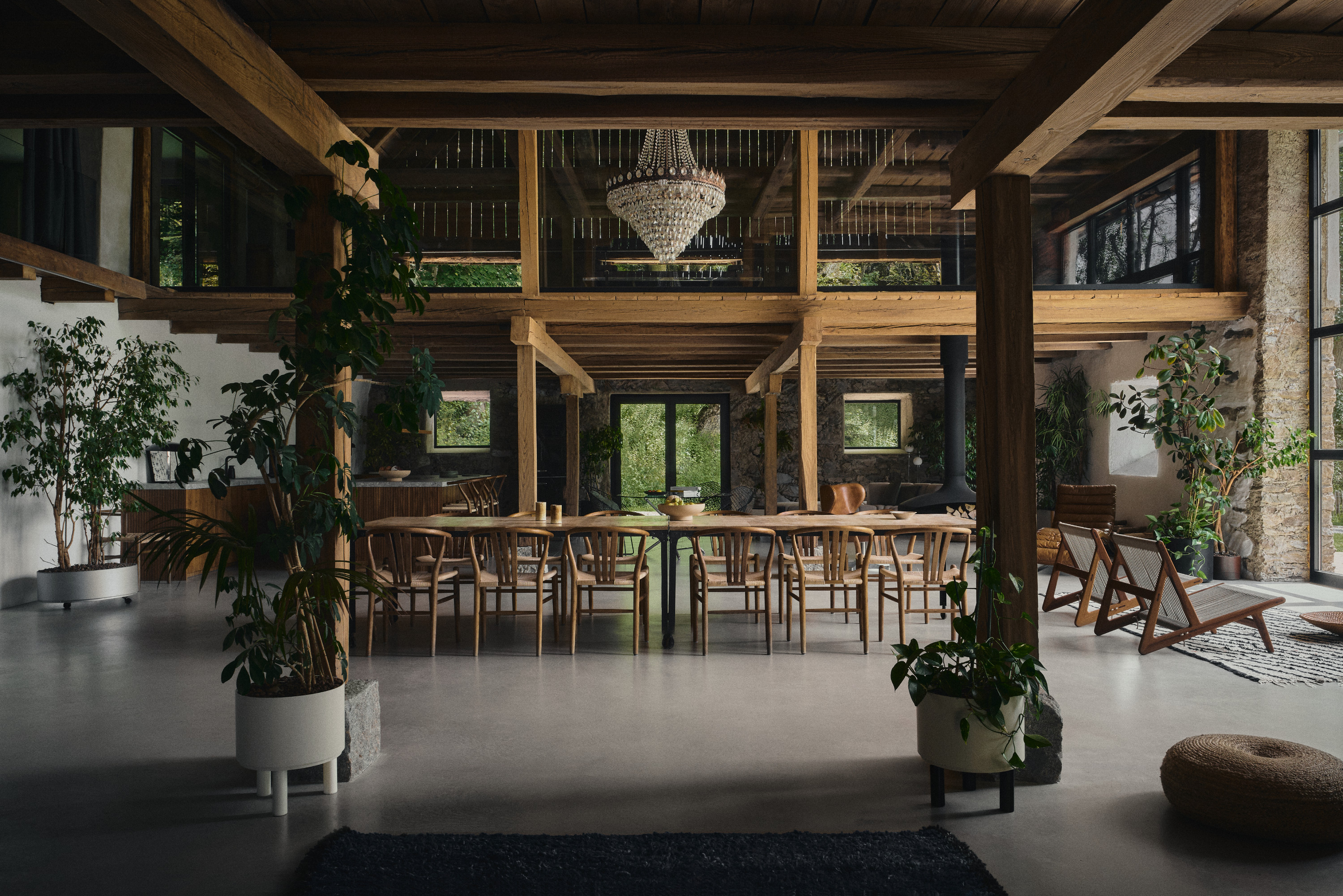 The converted barn interior with a long bar and chandelier