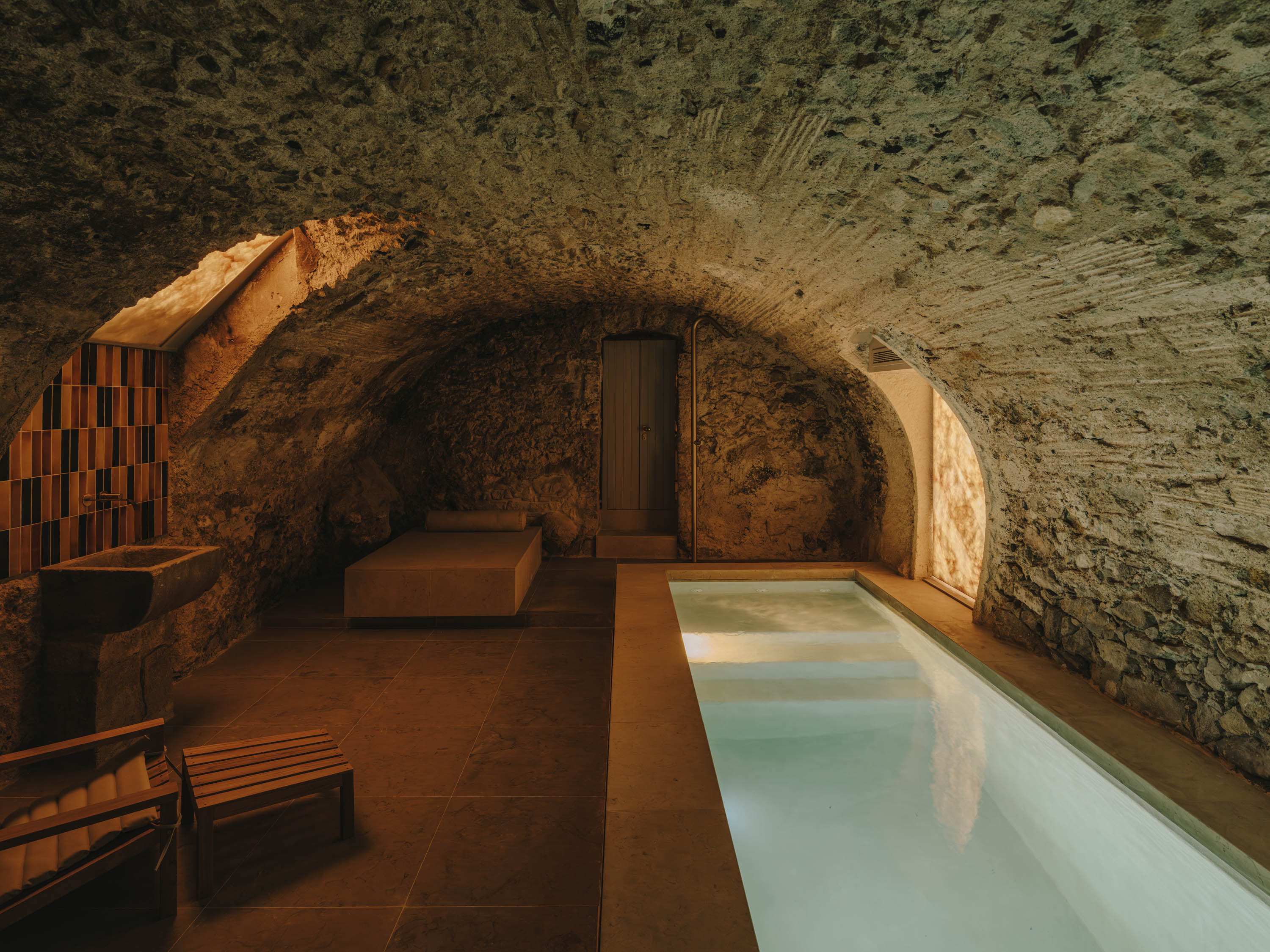 Vaulted stone cellar with a long indoor pool