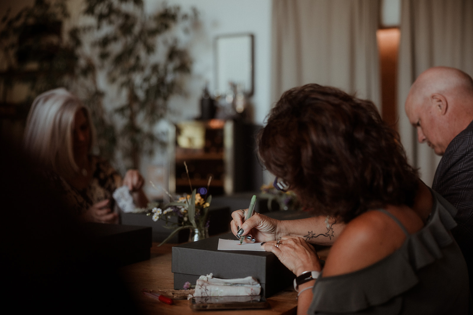 Participants writing at a table during a session