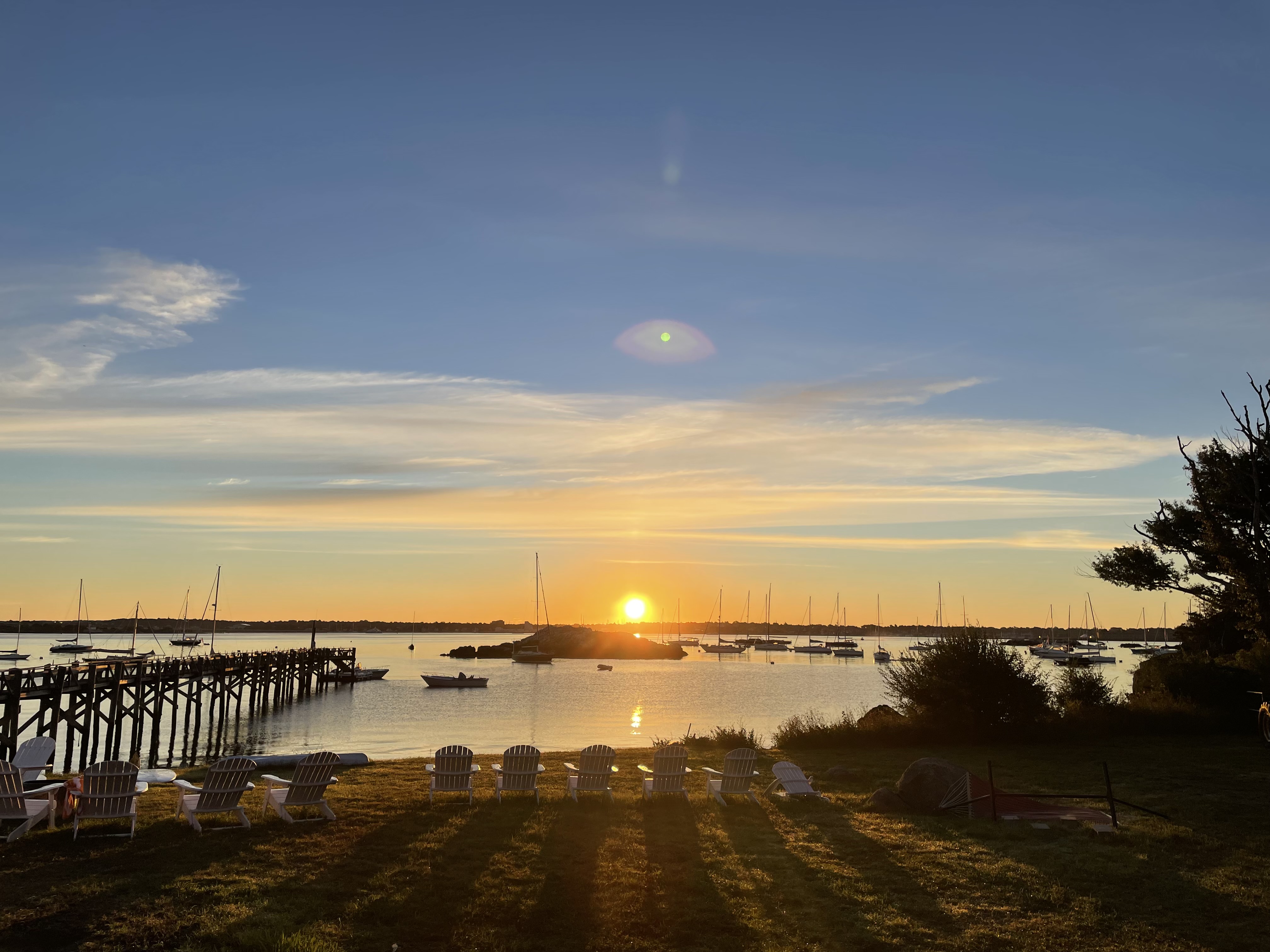 Sunset over the harbour with a pier and moored boats