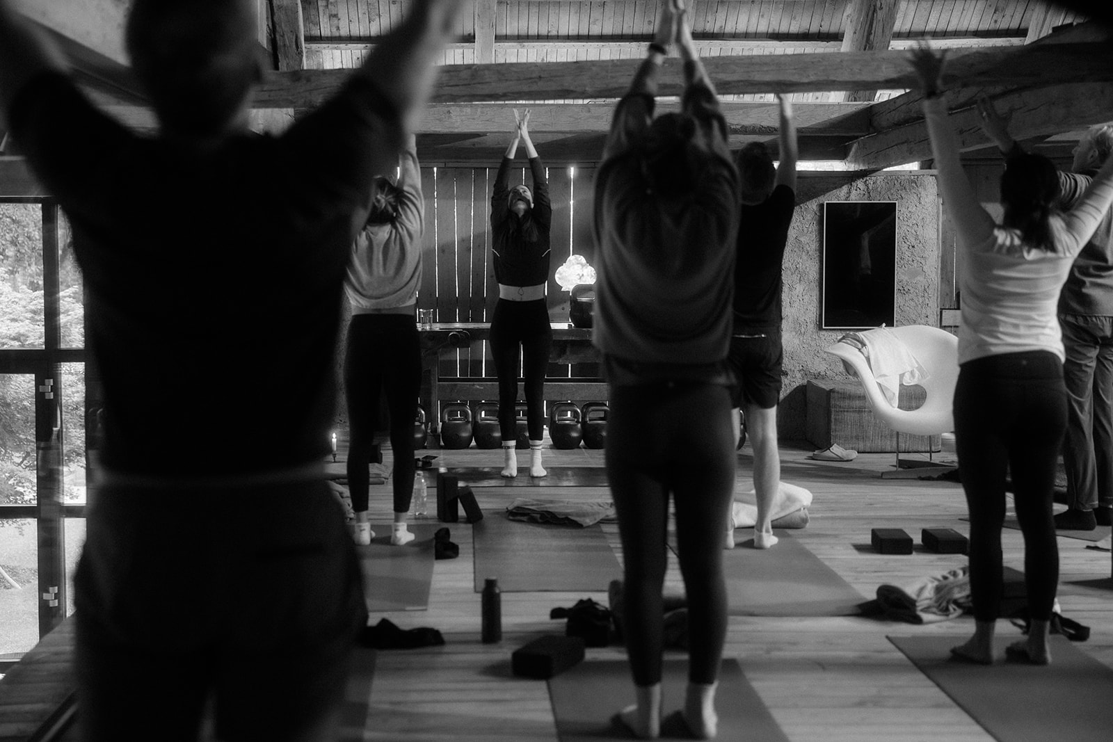 Silhouettes of a group stretching in the gym