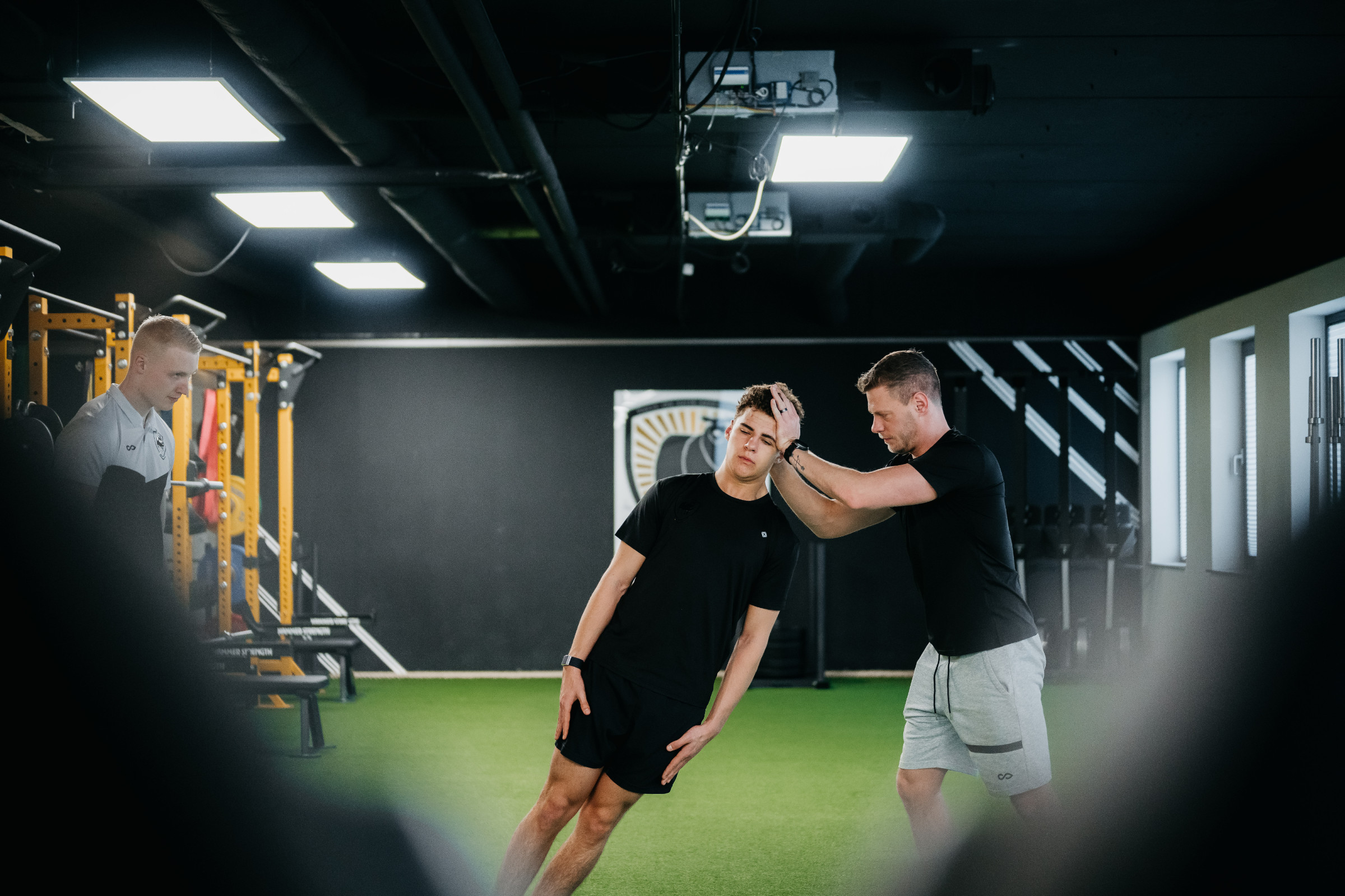 A coach demonstrating a movement in the gym