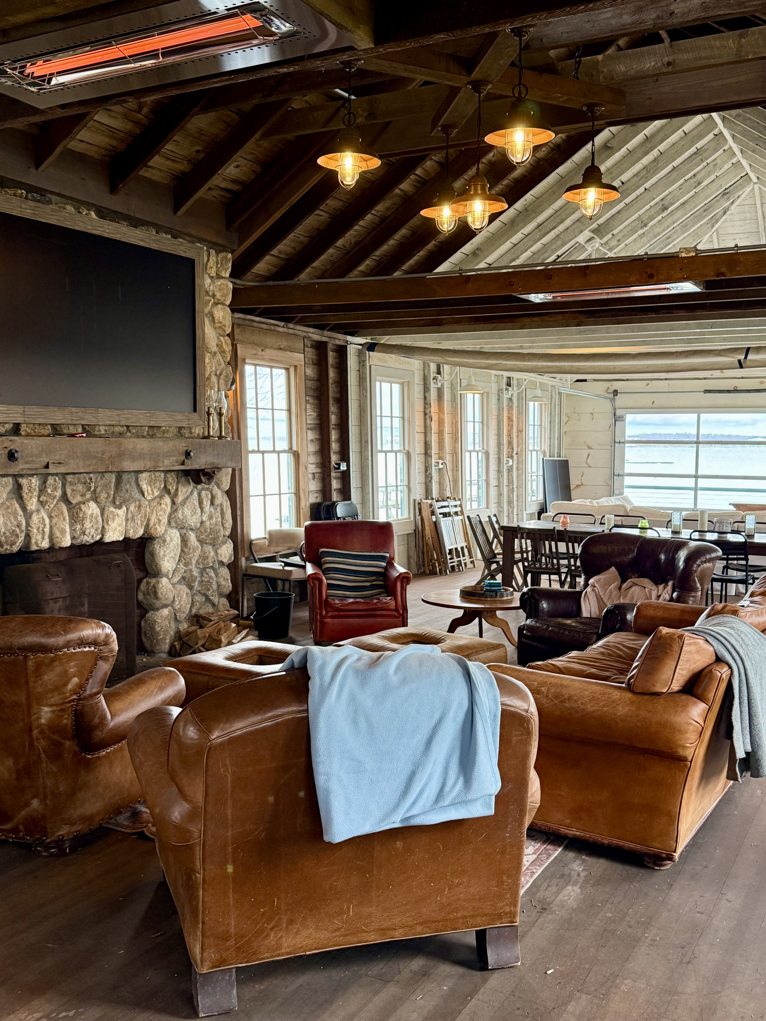Boathouse lounge with leather armchairs and a bar