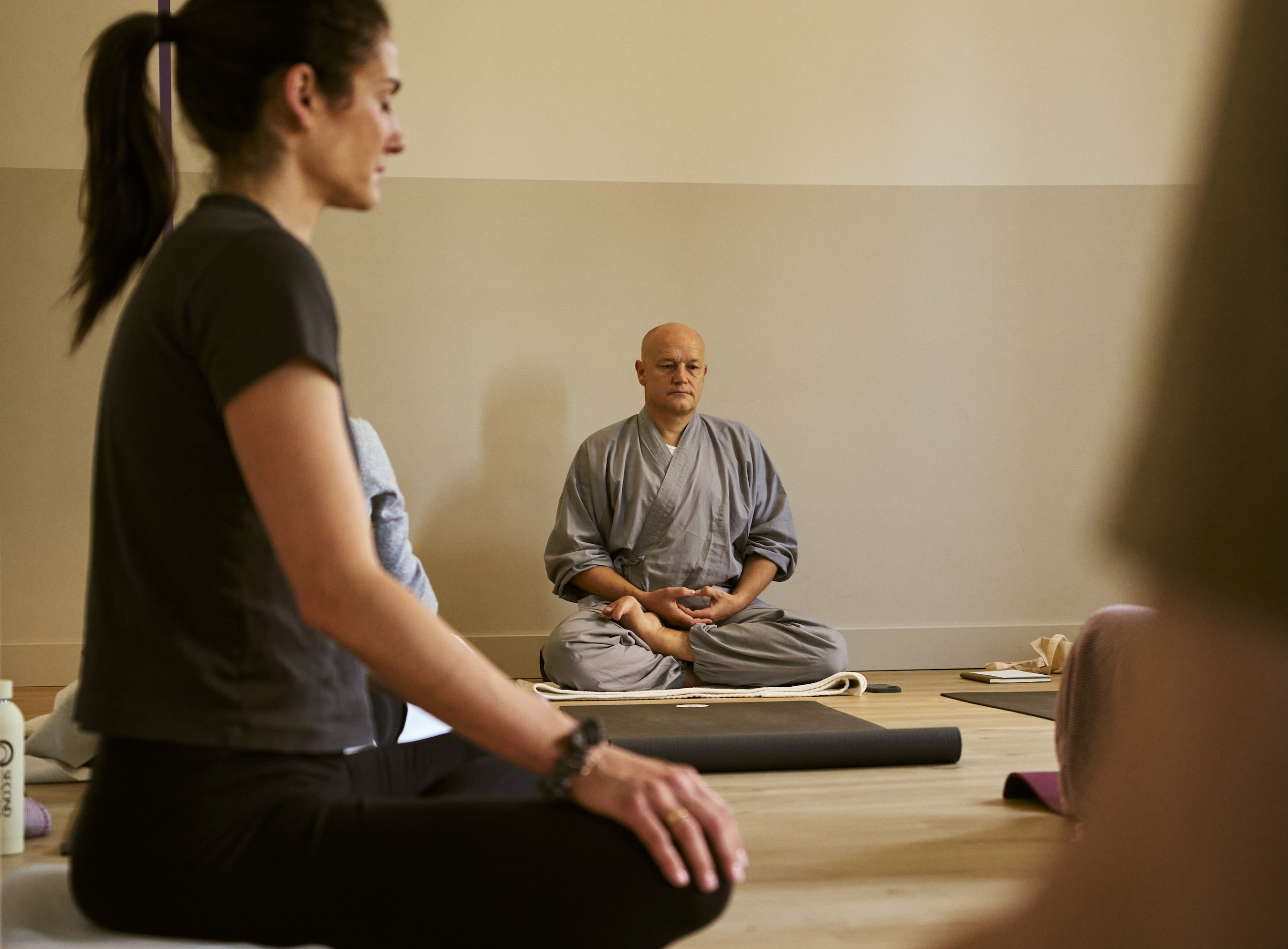 A meditation teacher leading a seated session
