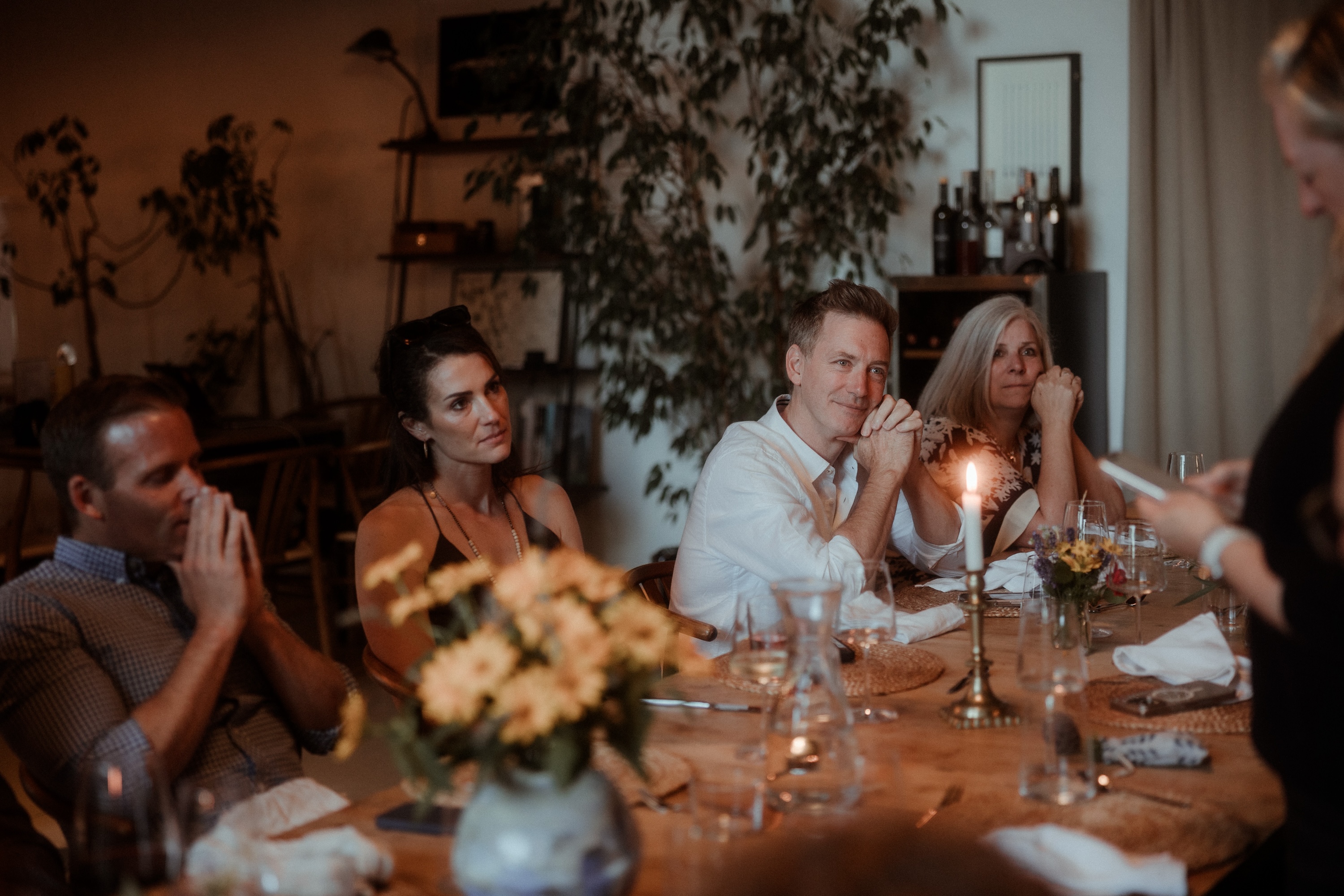 Candlelit dinner around a table indoors