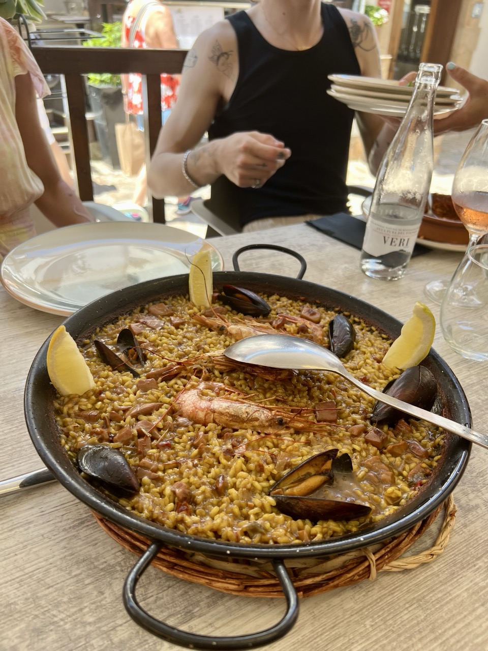 A pan of paella served at the table