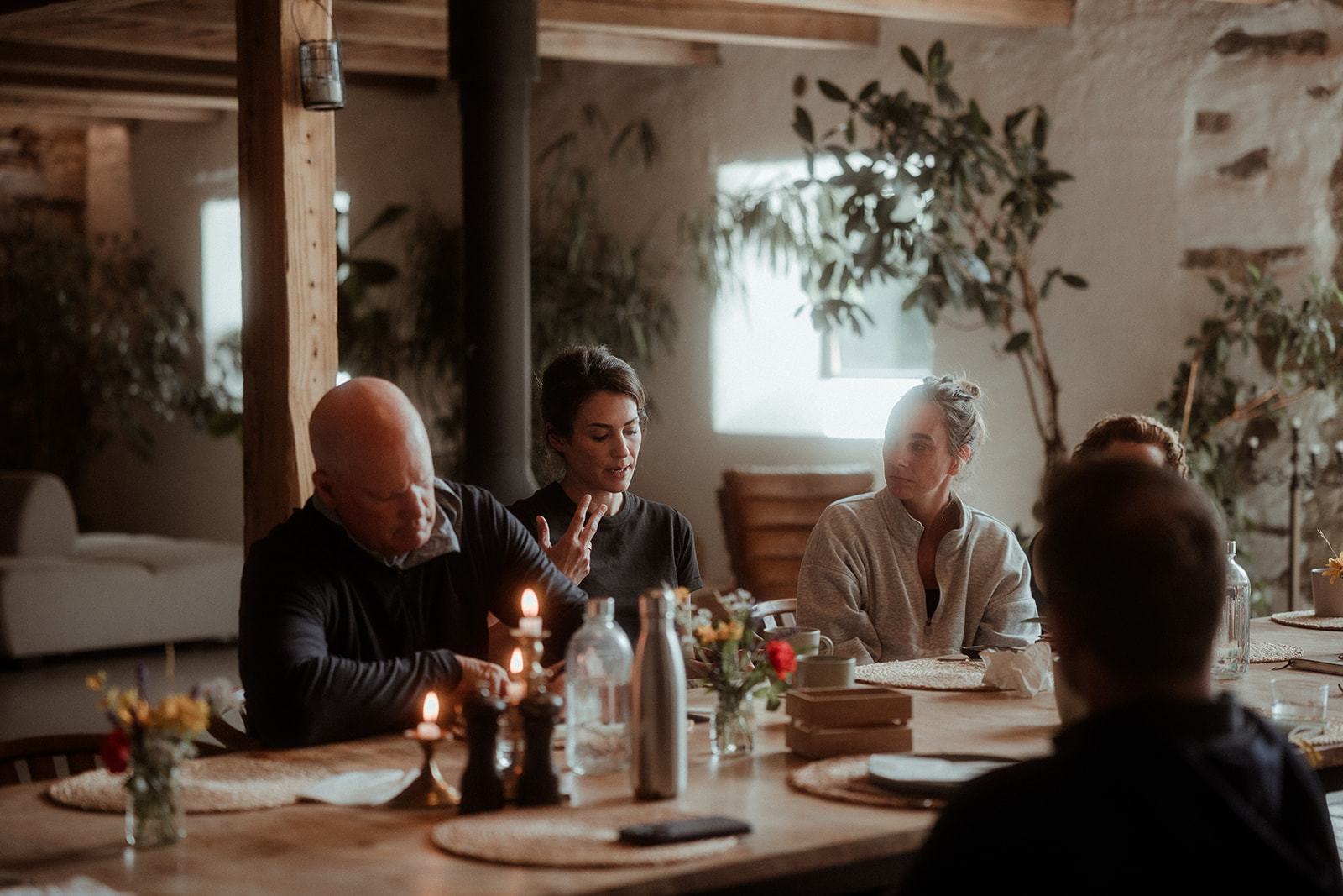Guests around a candlelit dinner table