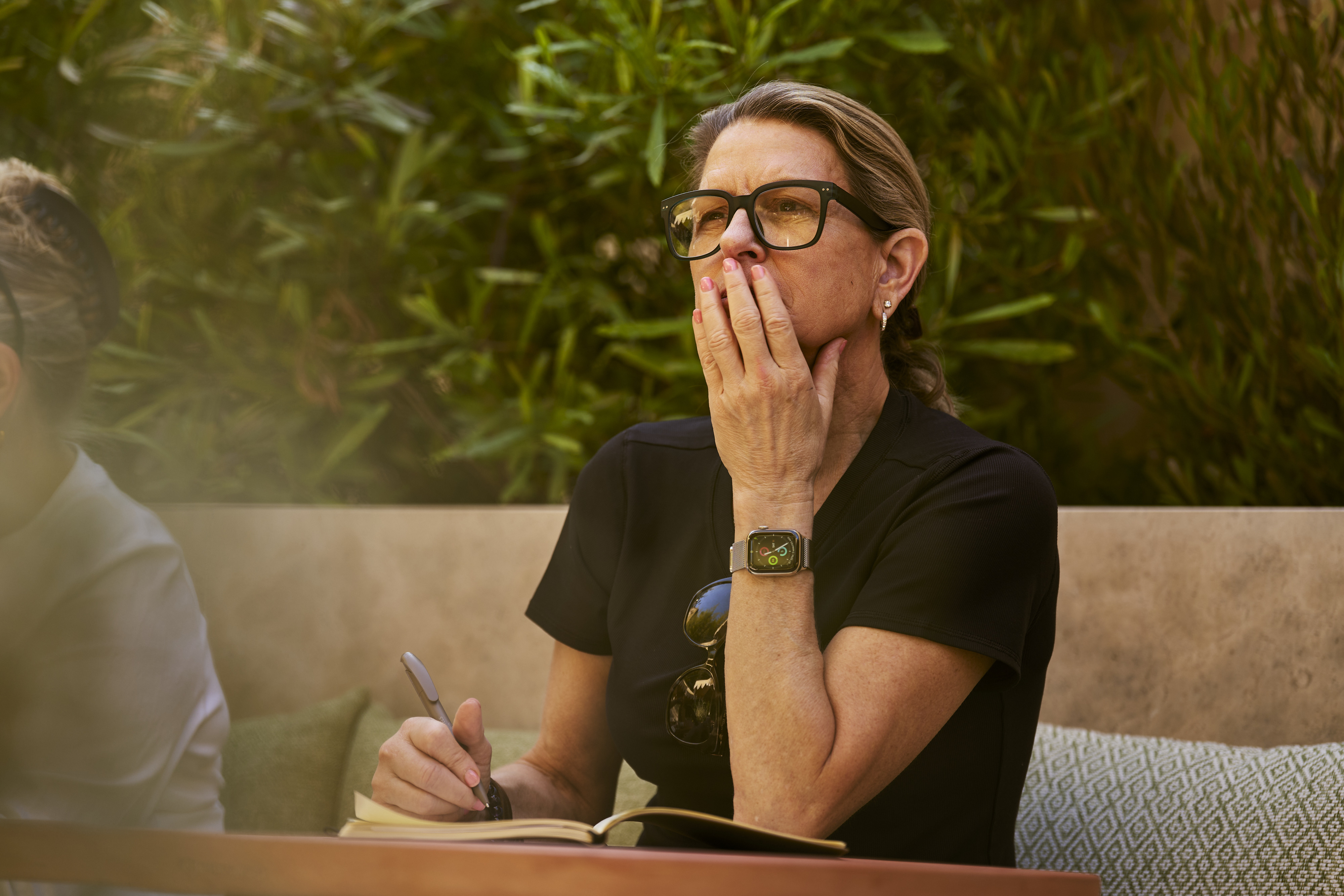A participant pausing while writing in a notebook