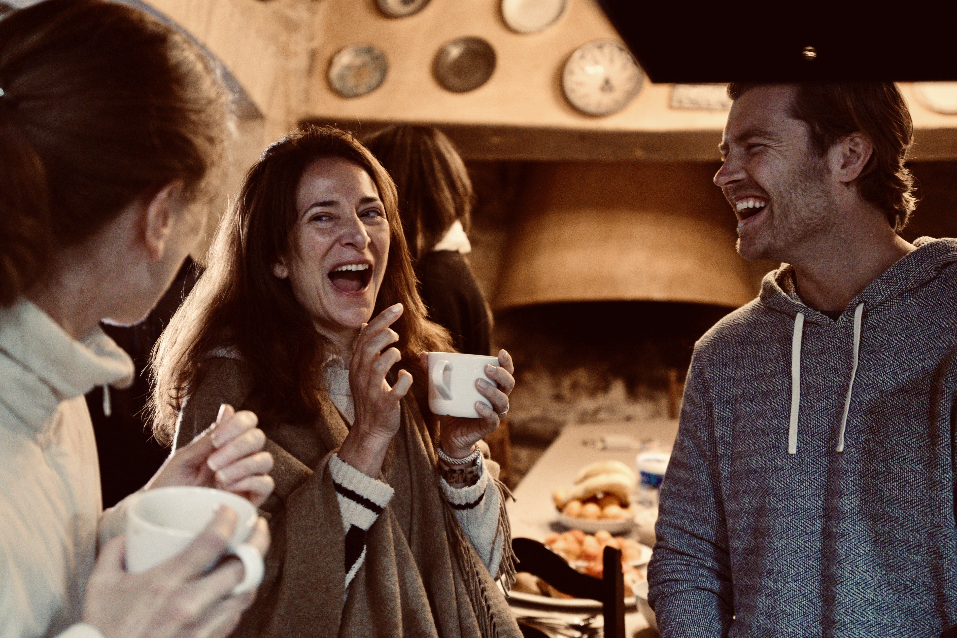 Two participants laughing together over coffee