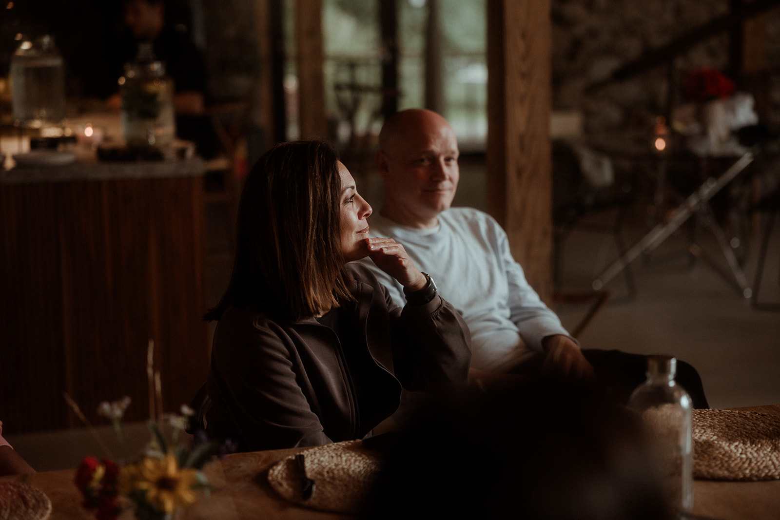 Two participants talking closely at an evening gathering