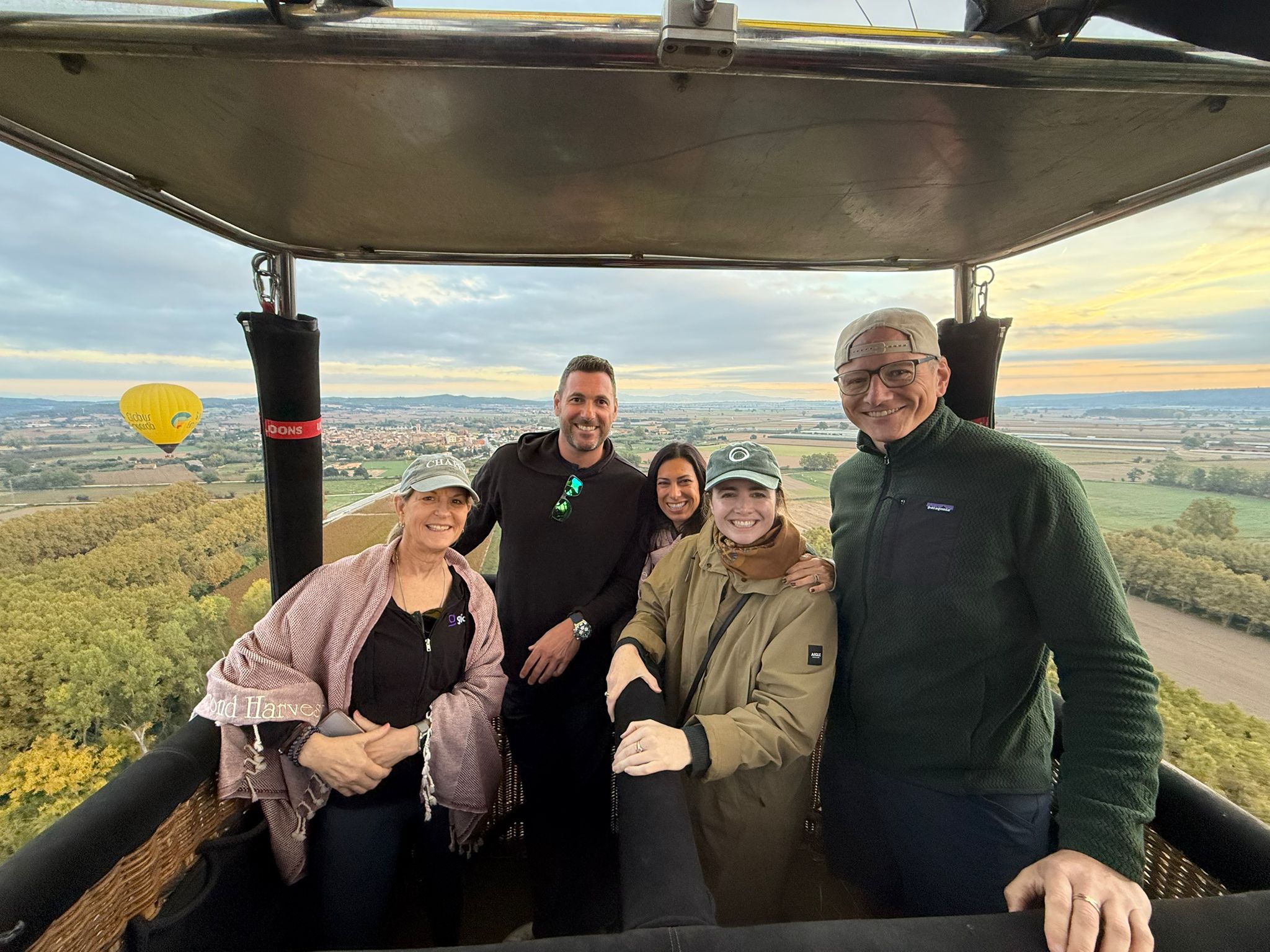 The group in a hot-air balloon basket at sunrise