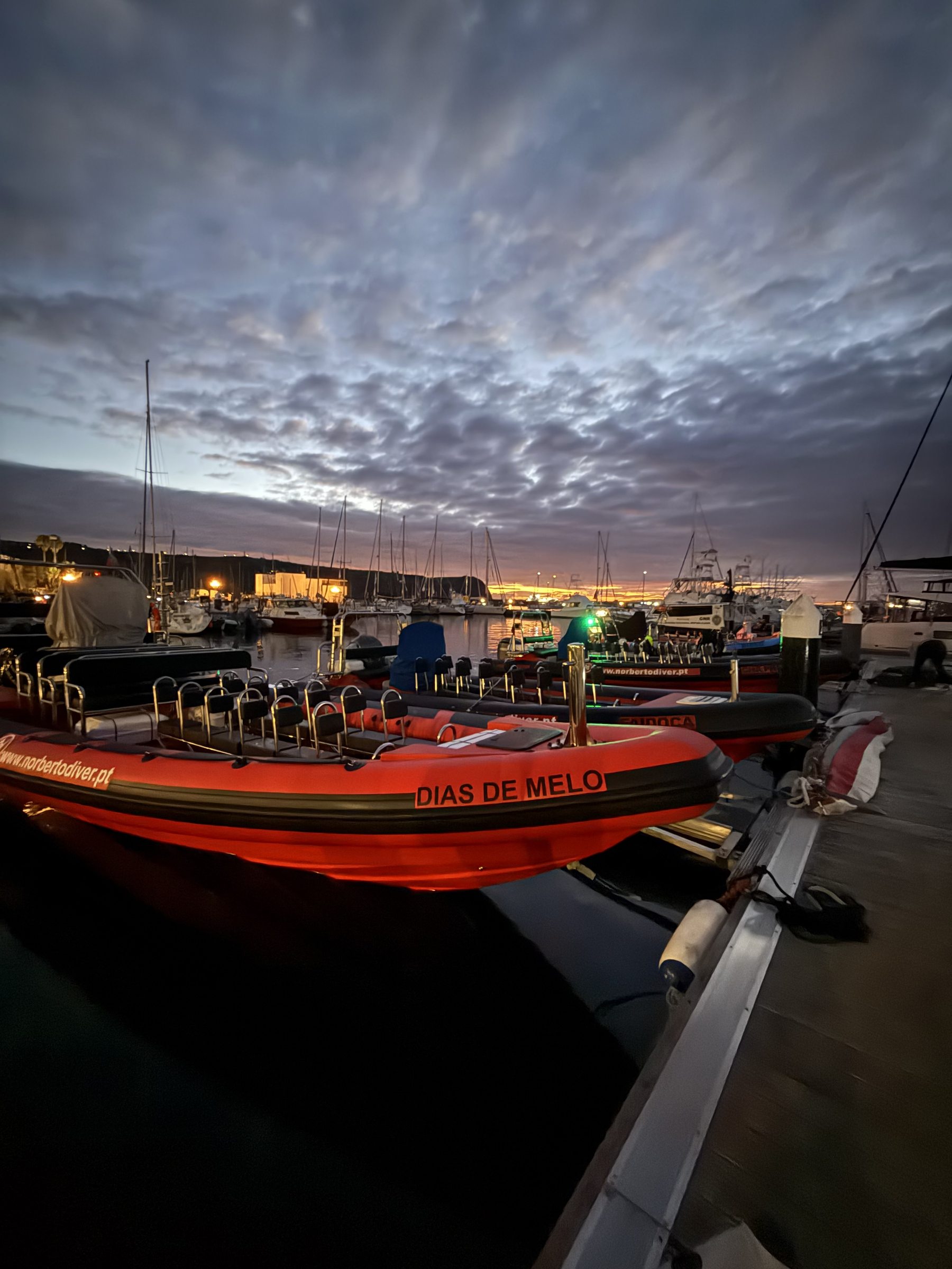 A rigid inflatable boat moored at Horta marina at dusk