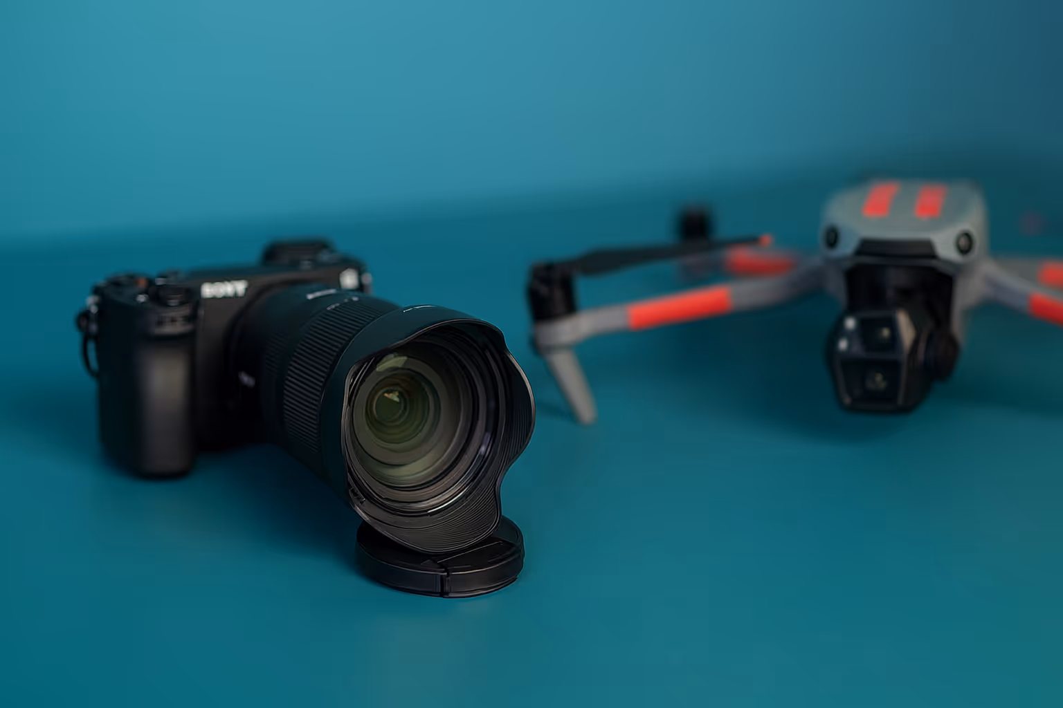 An image of a camera and drone on a blue background
