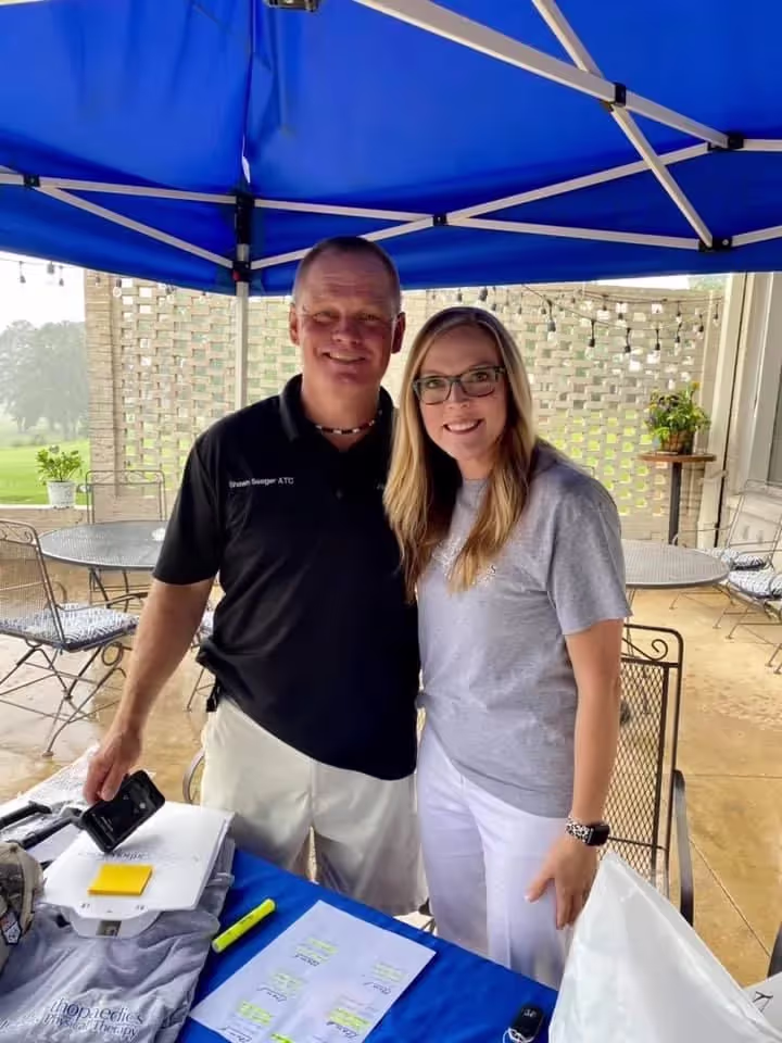 AOA Sports Medicine pratitioners outside under a tent.
