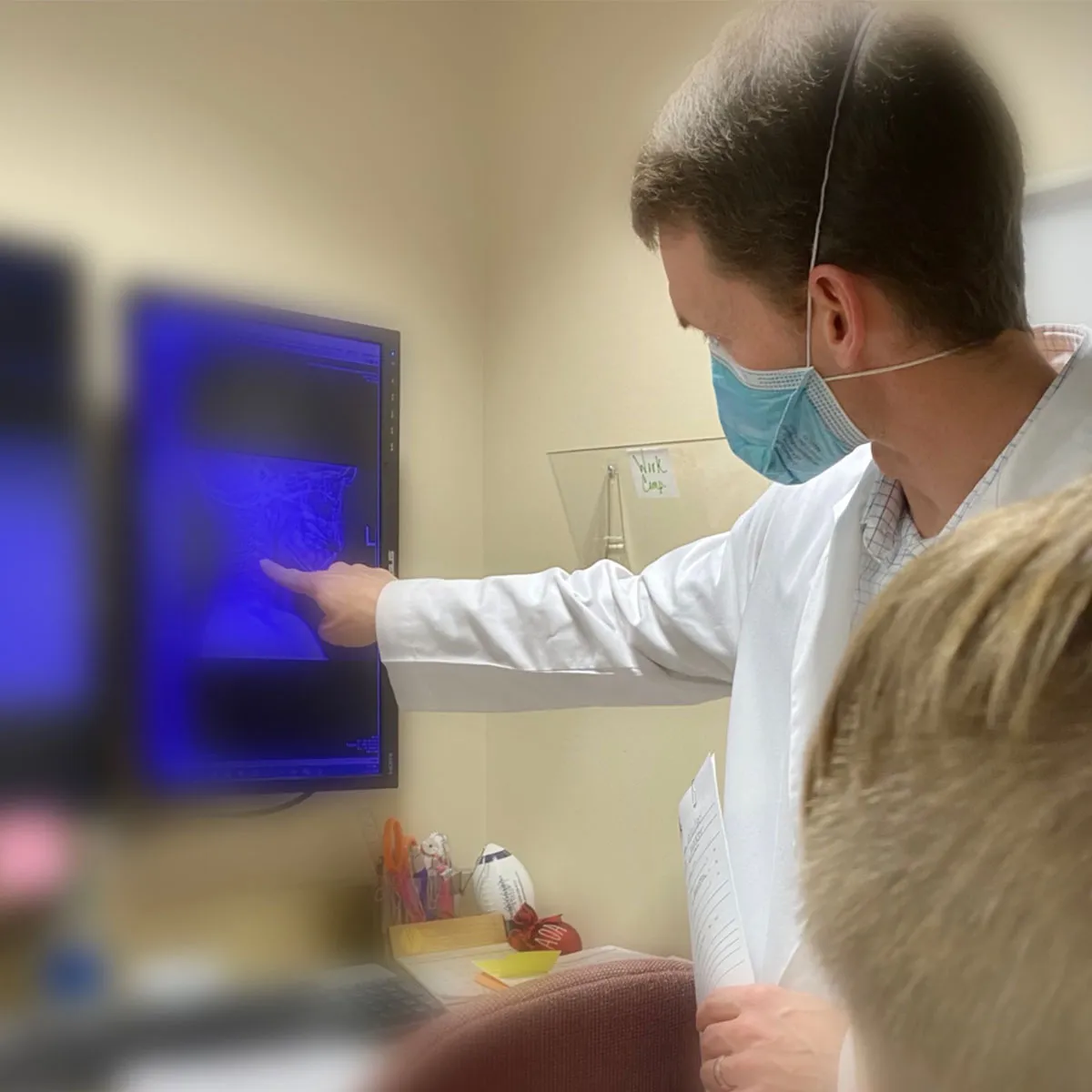 Dr. Tippets examining an x-ray.