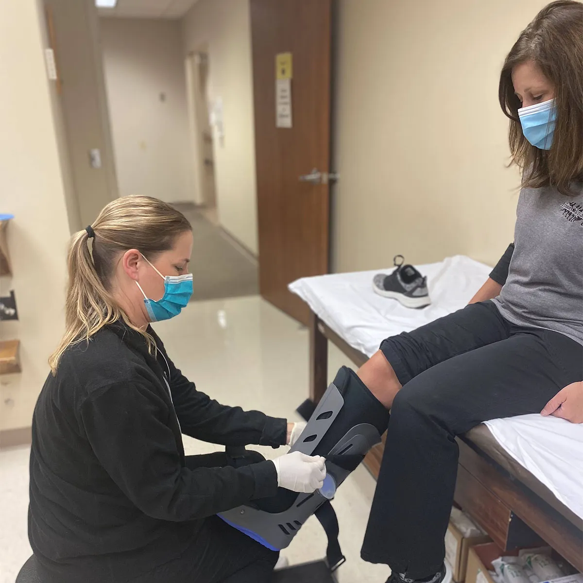 A DME practitioner adjusting a leg piece.