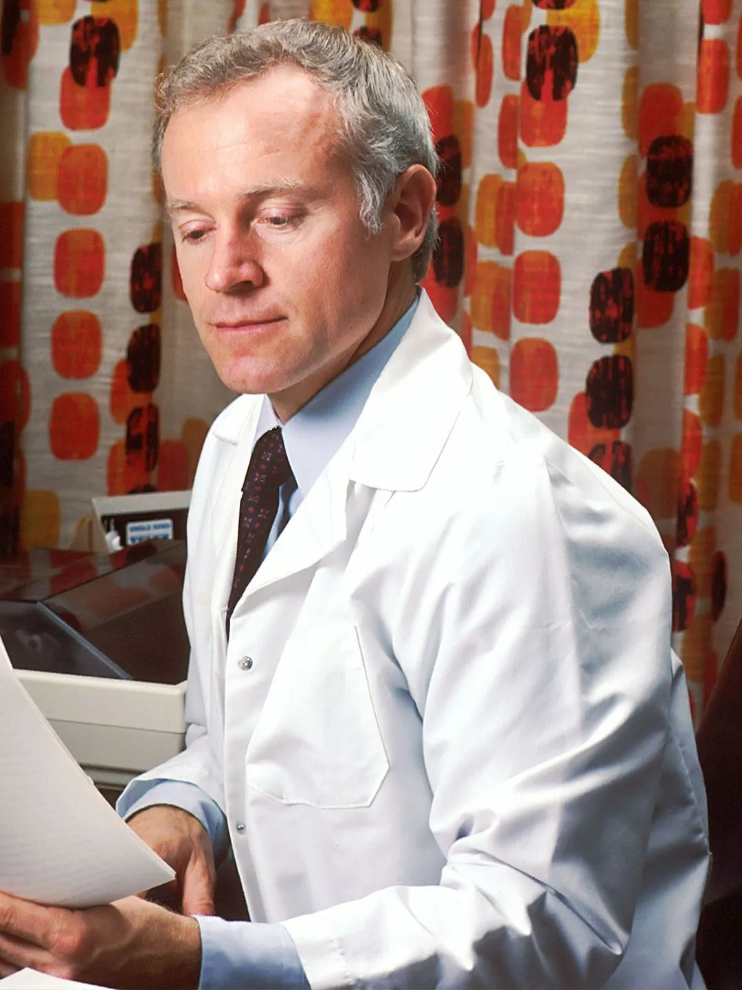 Doctor reading a patient report.