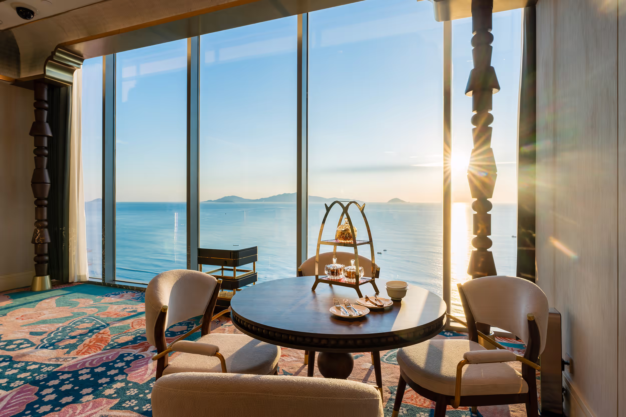 Private refreshment table at Sky Casino, set with tea service before sweeping sea and Cù Lao Chàm Island views.
