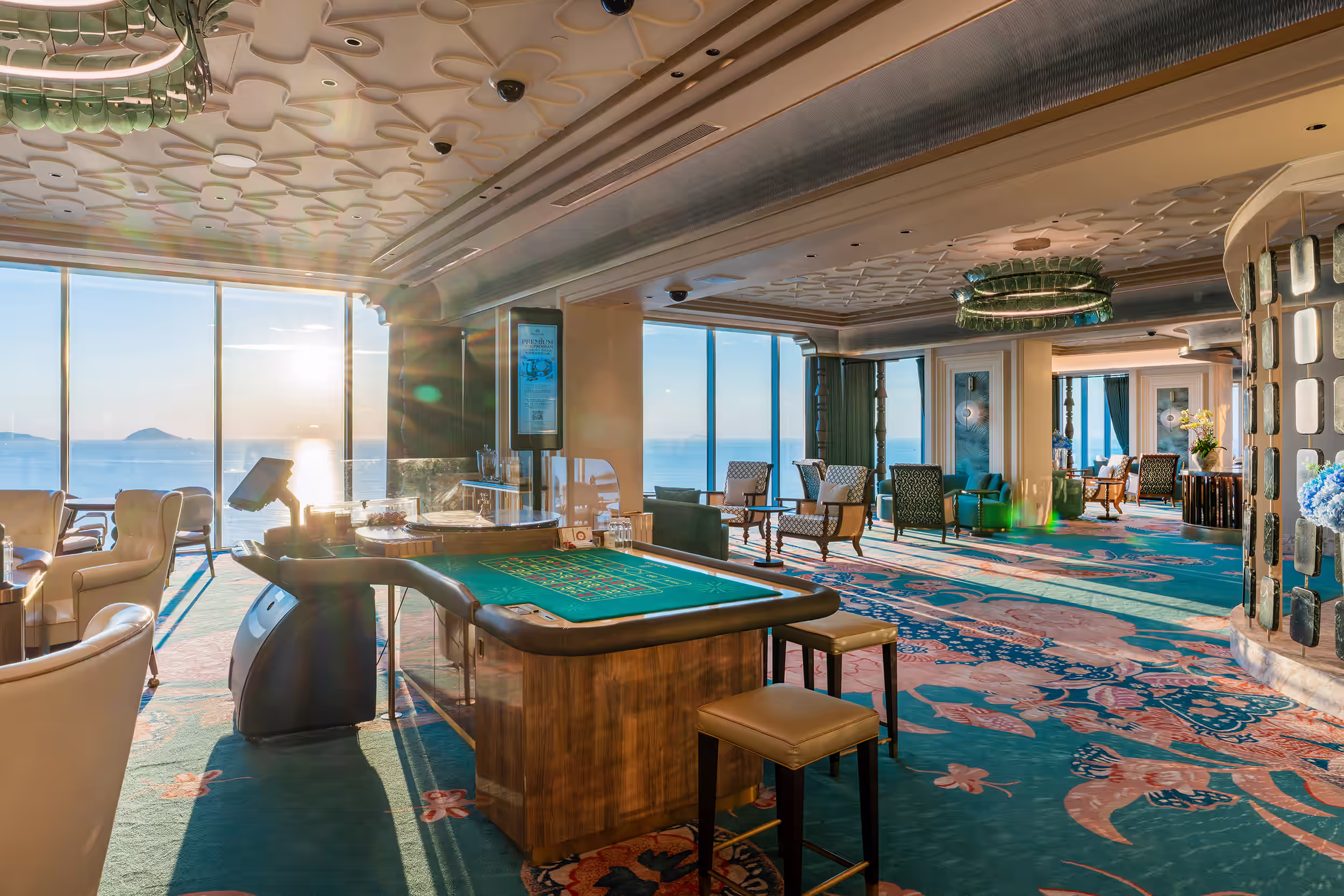 Ocean-view gaming floor at Sky Casino, Hoiana Resort & Golf, featuring a roulette table and sunlit lounge seating.

