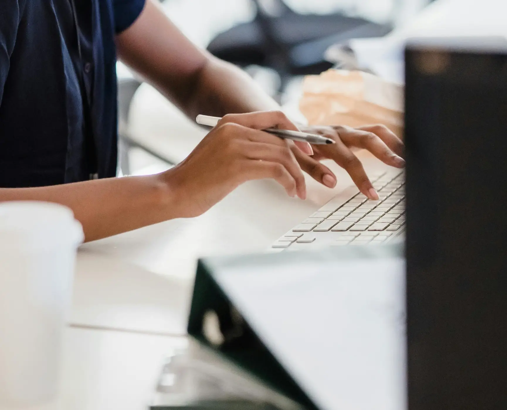 Hands typing on a keyboard