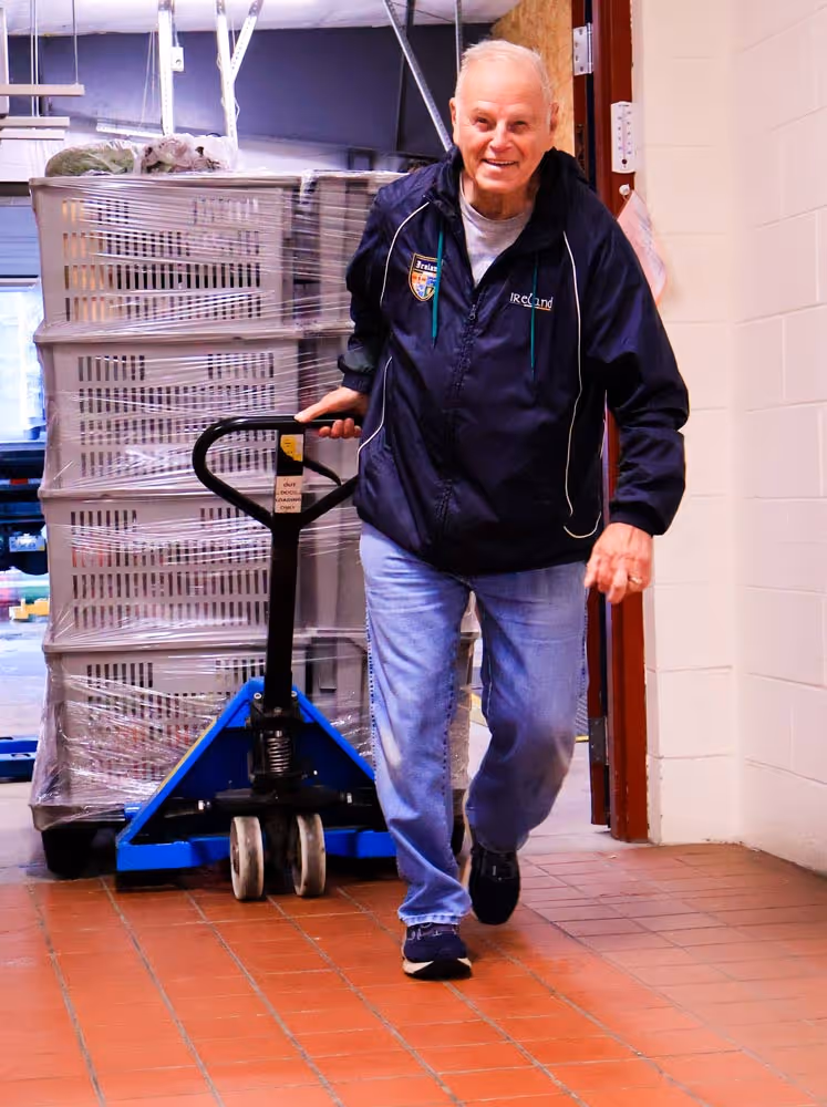 Fondy Food Pantry male volunteer pulling a pallet of boxes at the pantry